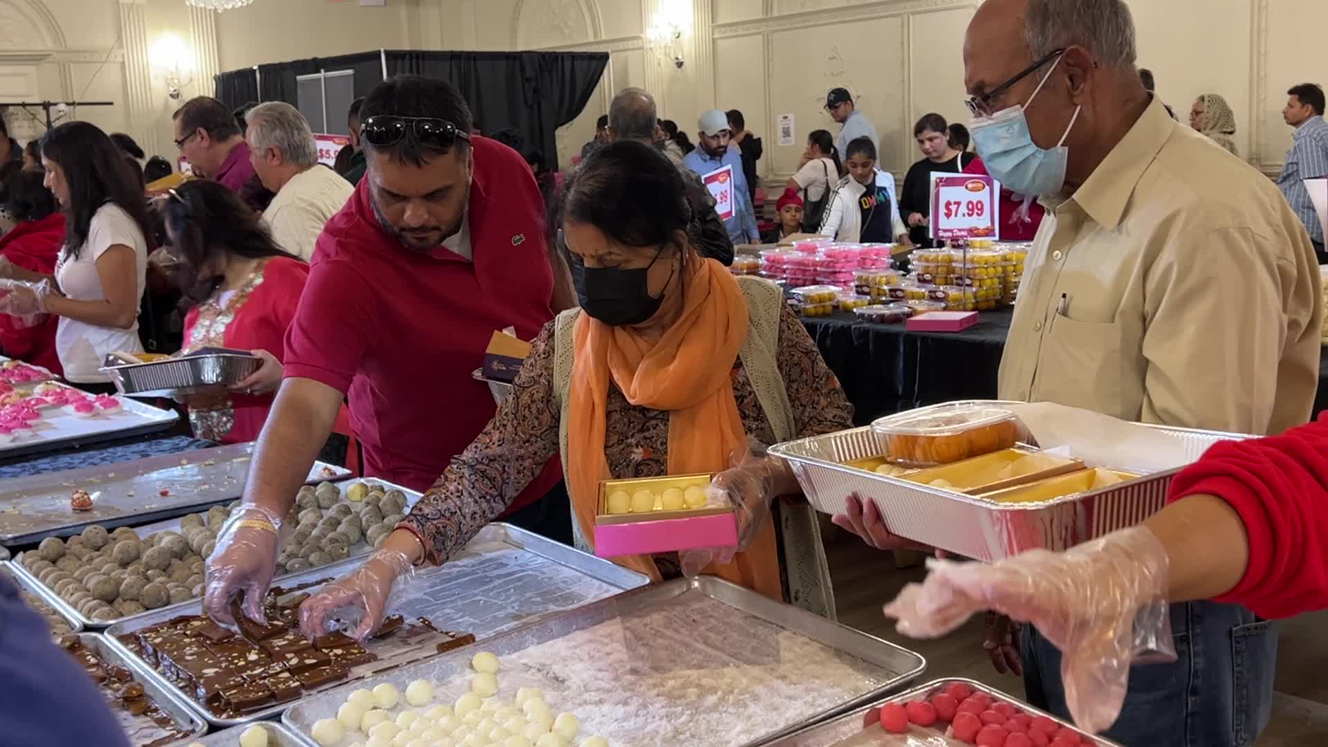 People purchase Indian sweets for the festival of Diwali 