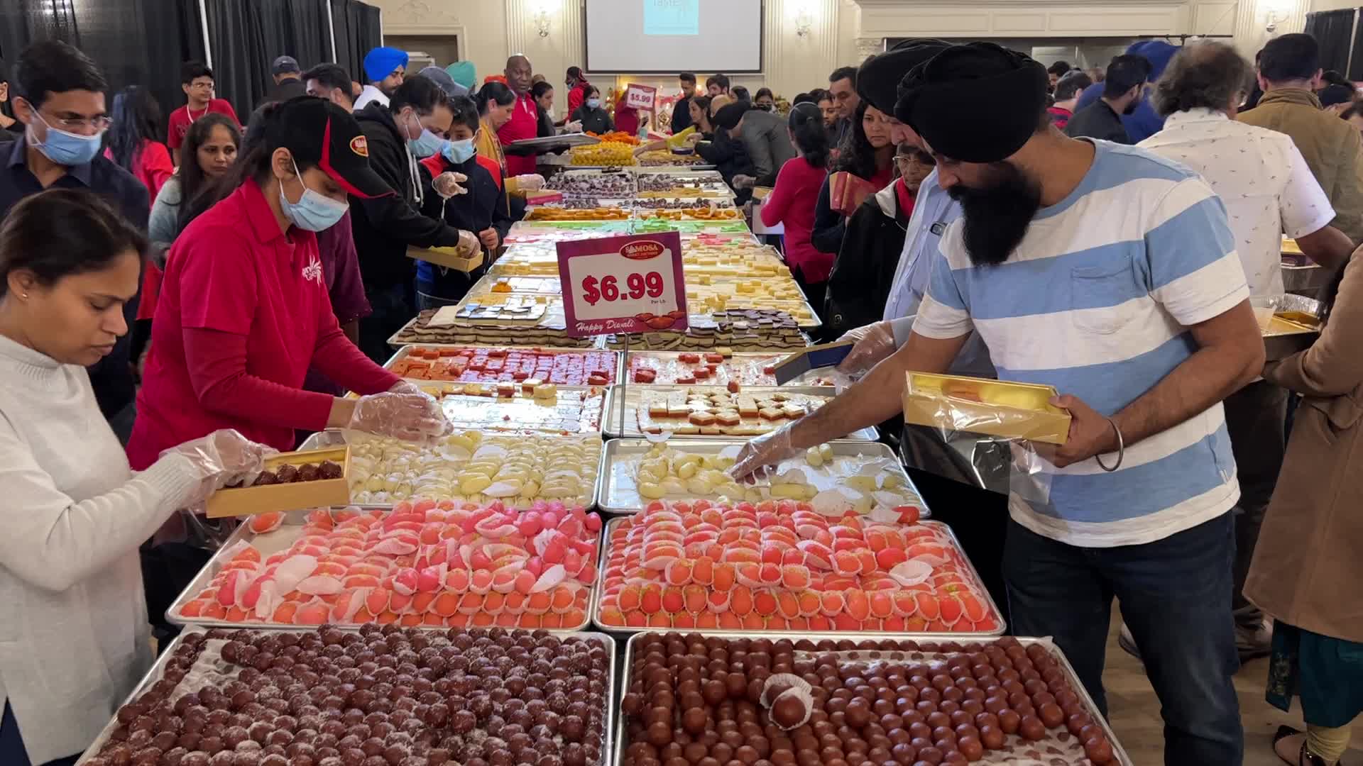 People purchase Indian sweets for the festival of Diwali 