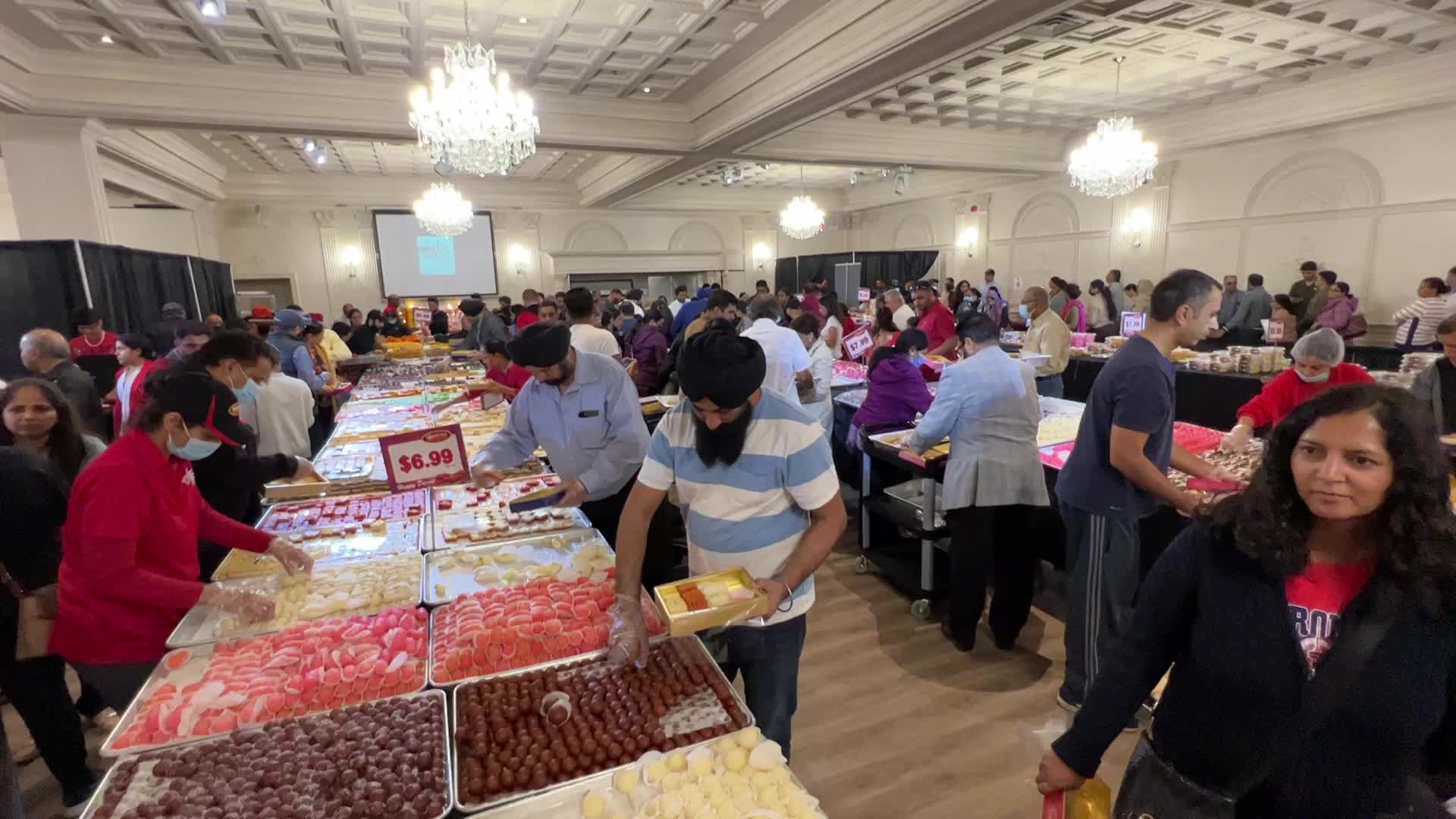People purchase Indian sweets for the festival of Diwali 