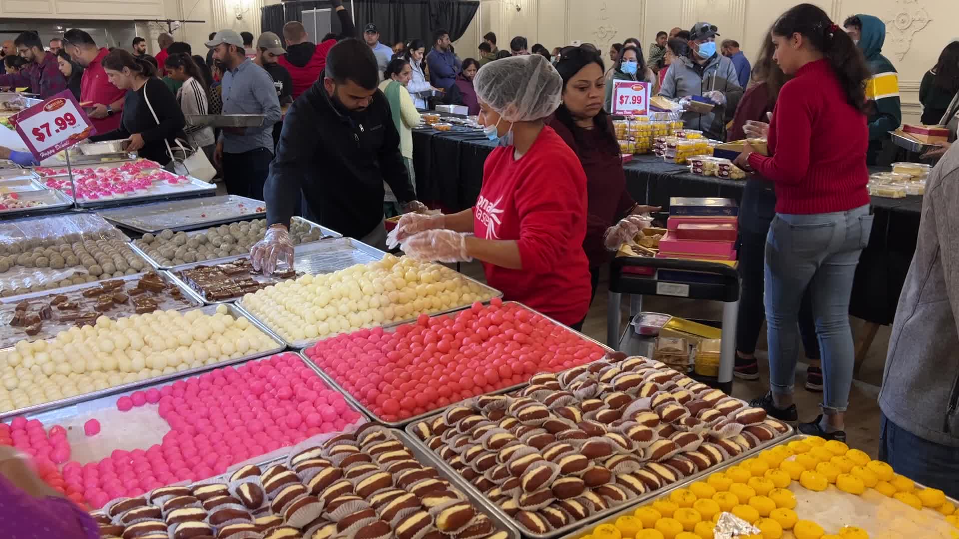 People purchase Indian sweets for the festival of Diwali 