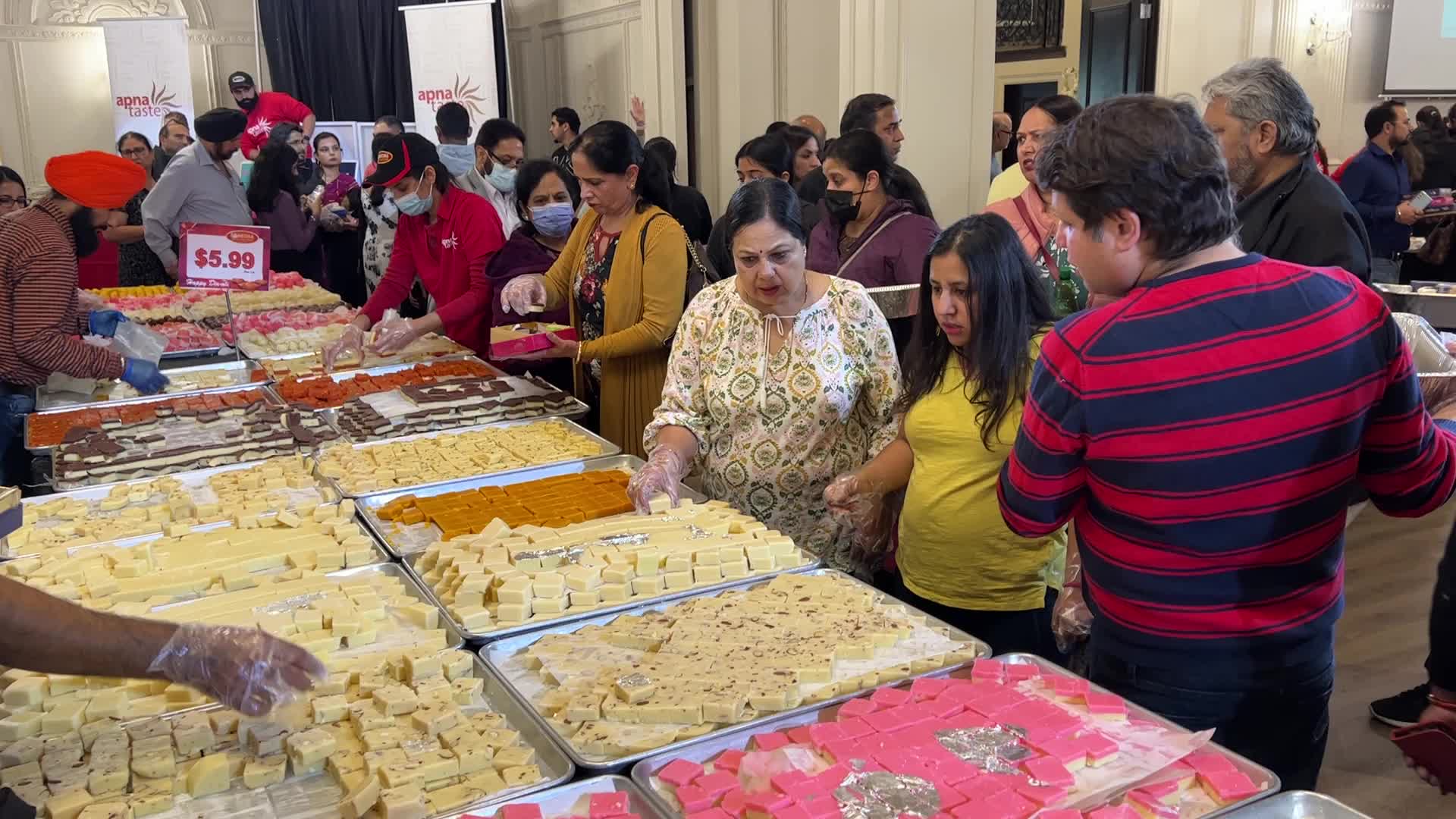 People purchase Indian sweets for the festival of Diwali 