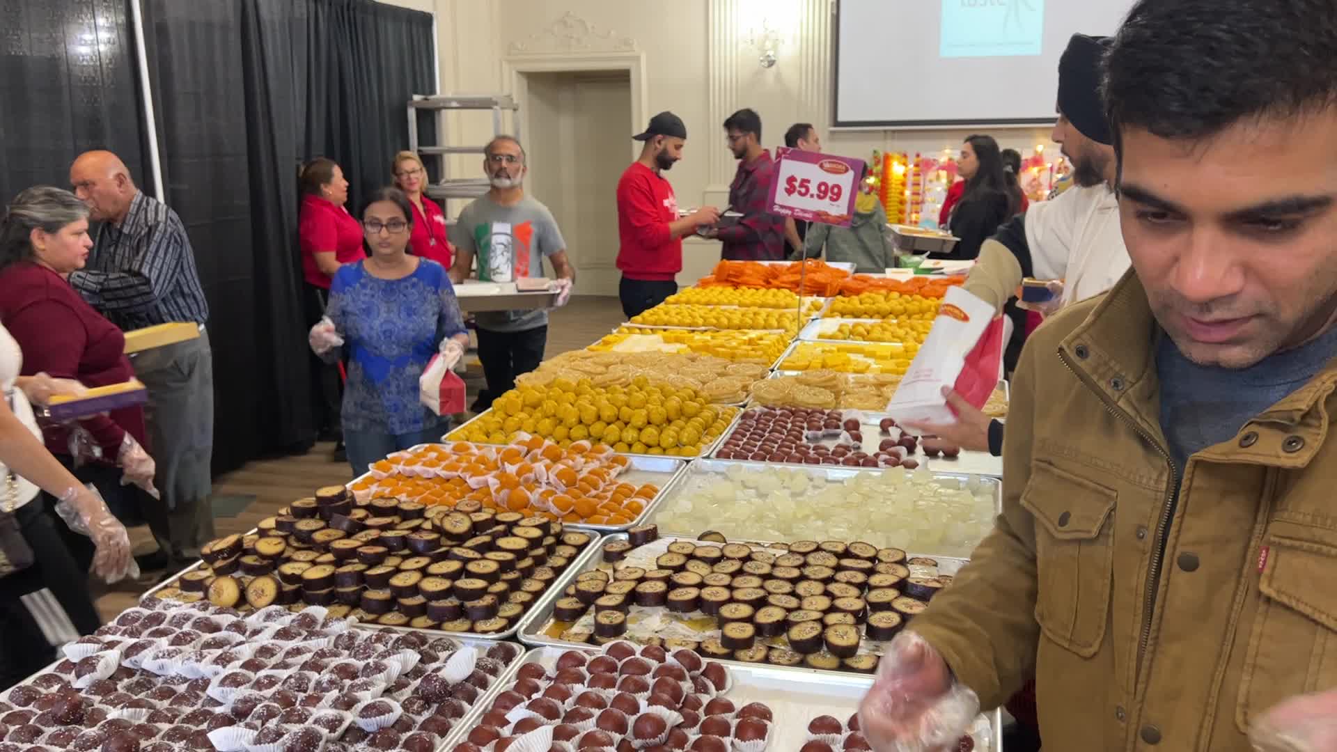 People purchase Indian sweets for the festival of Diwali 