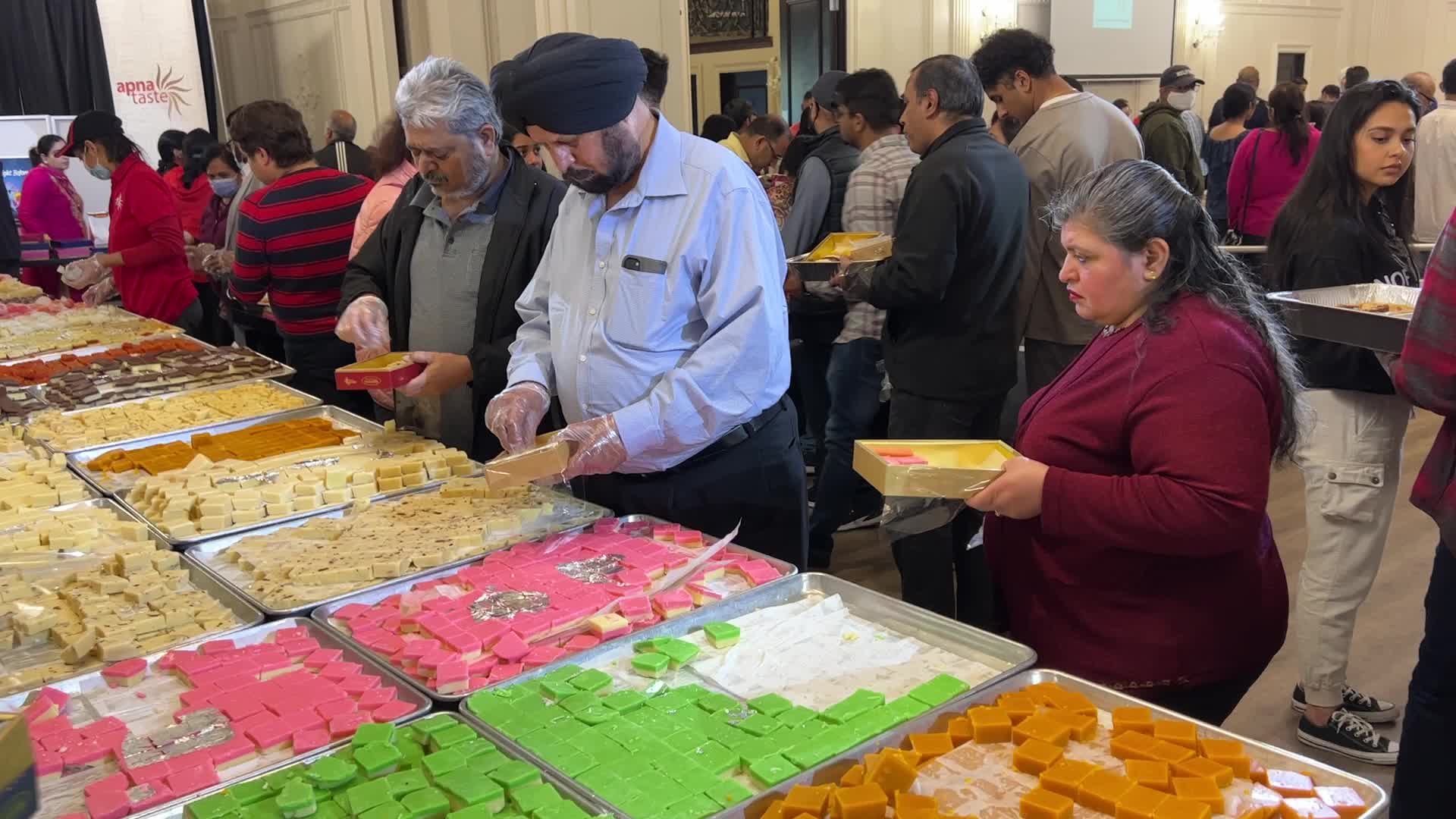 People purchase Indian sweets for the festival of Diwali 