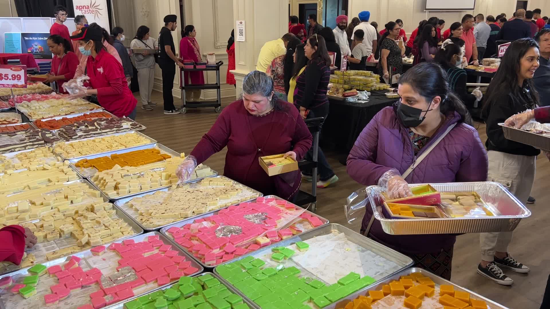 People purchase Indian sweets for the festival of Diwali 