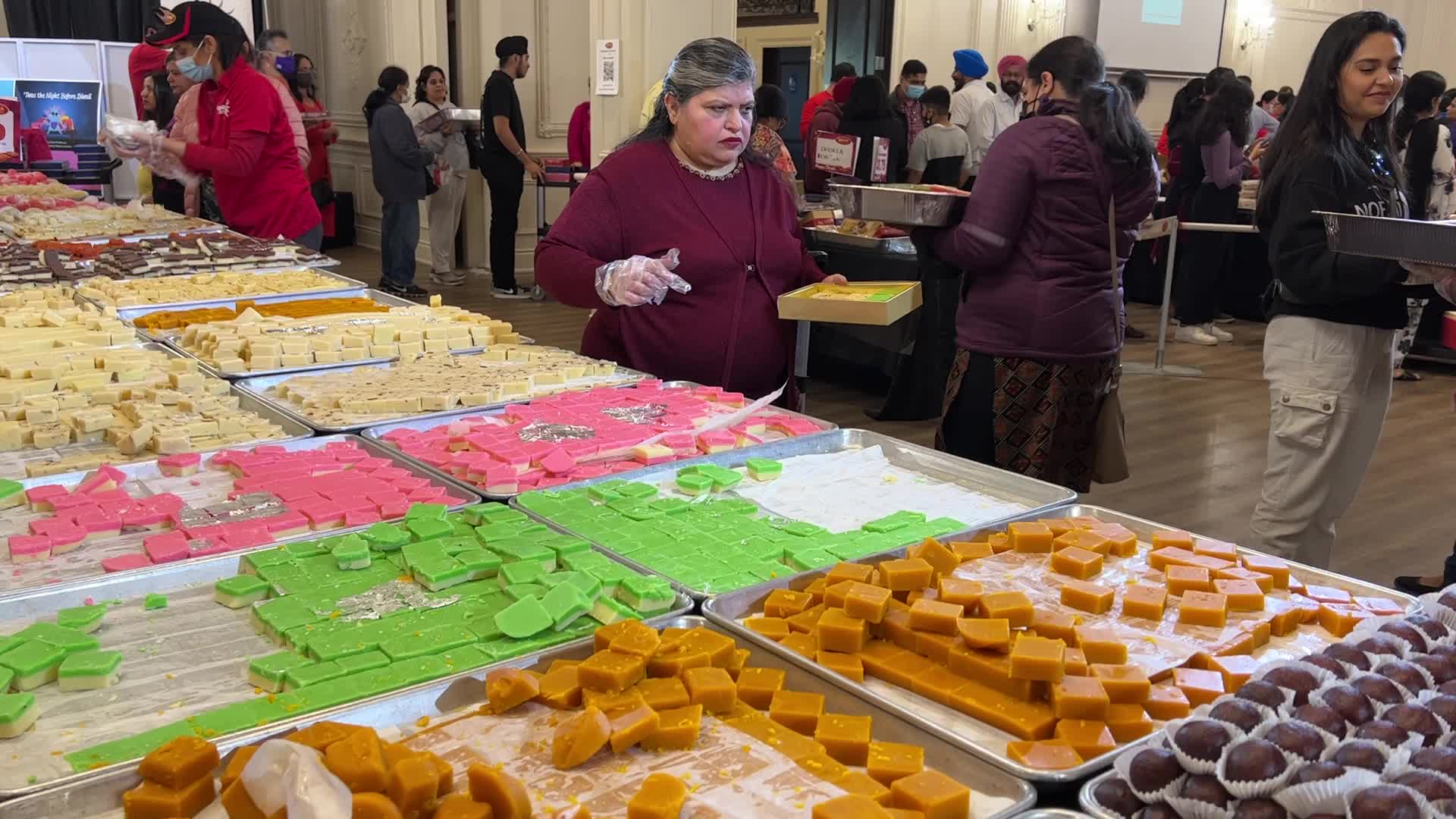 People purchase Indian sweets for the festival of Diwali 