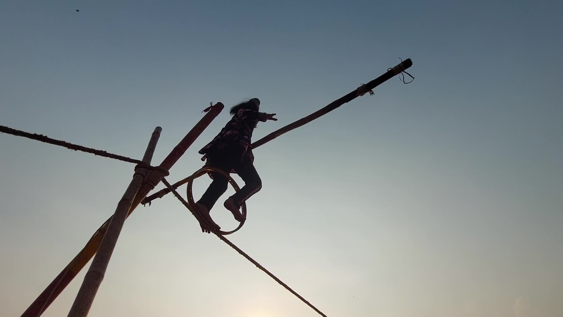 Indian Girl Undertakes a balancing act on a rope during a street show in Pushkar