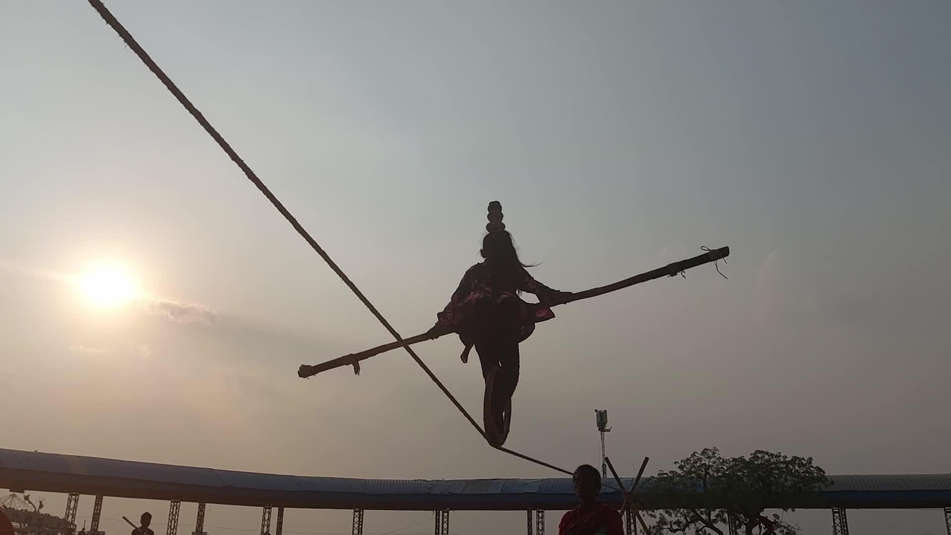 Indian Girl Undertakes a balancing act on a rope during a street show in Pushkar