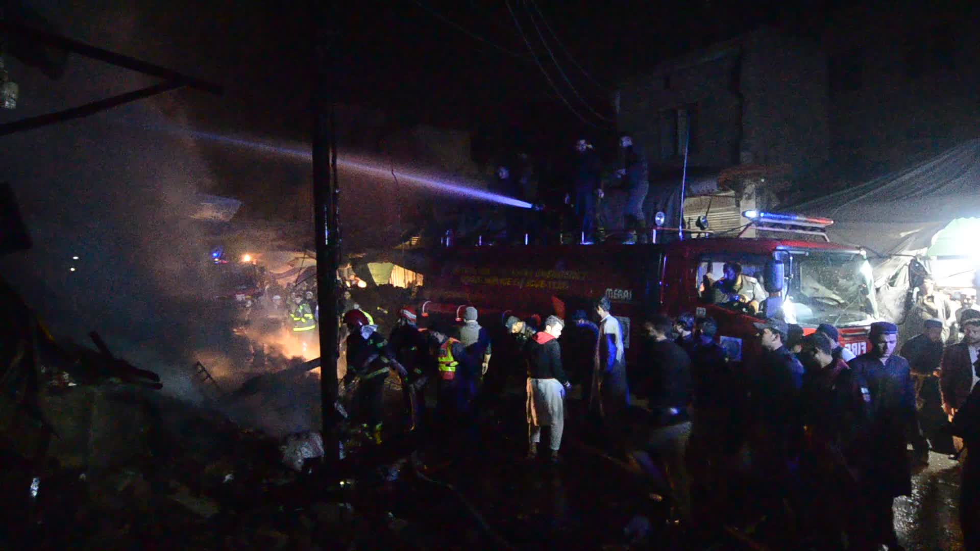 Firefighters At Work After a Fire In A Store In Peshawar, Pakistan