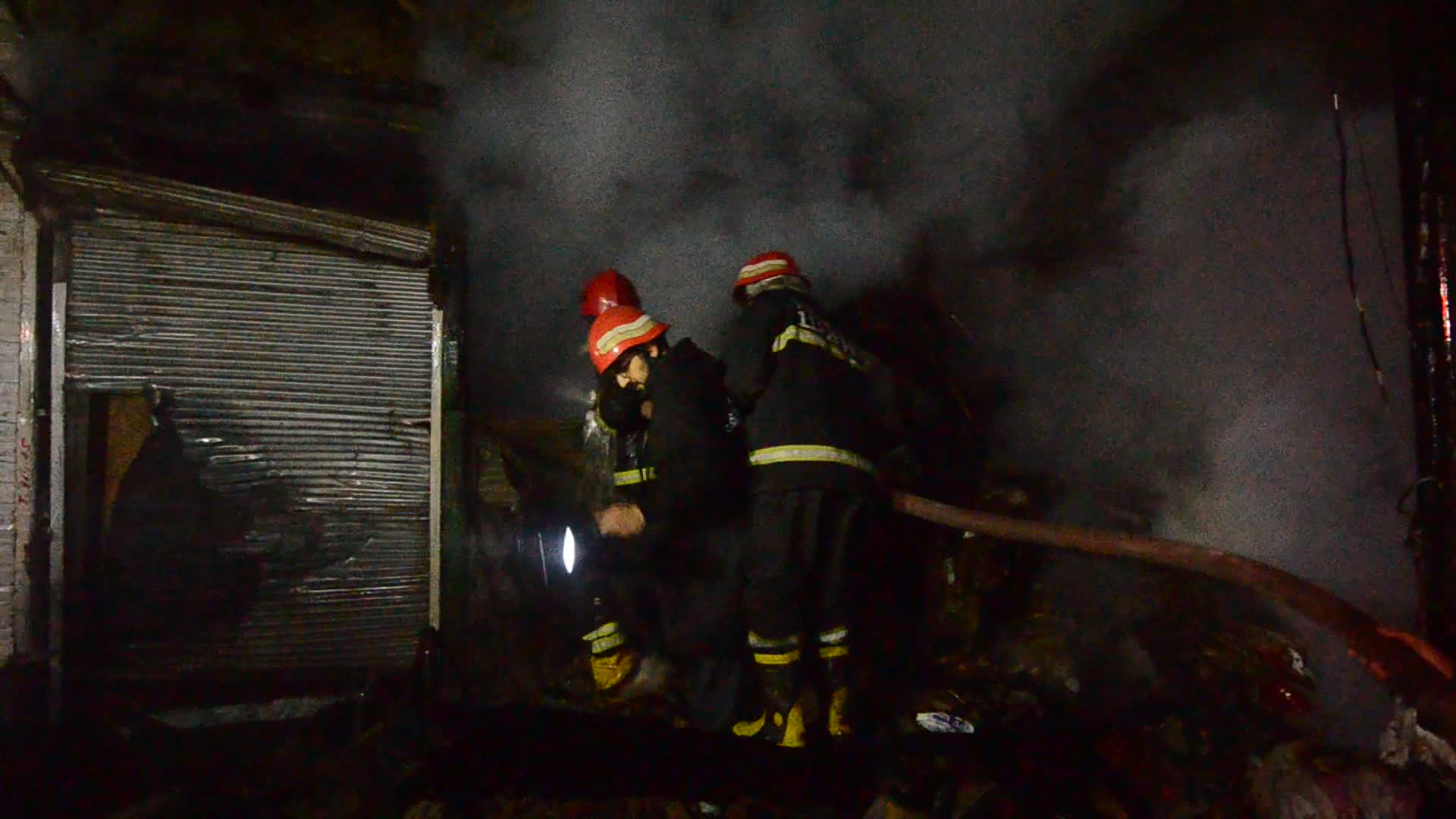 Firefighters At Work After a Fire In A Store In Peshawar, Pakistan