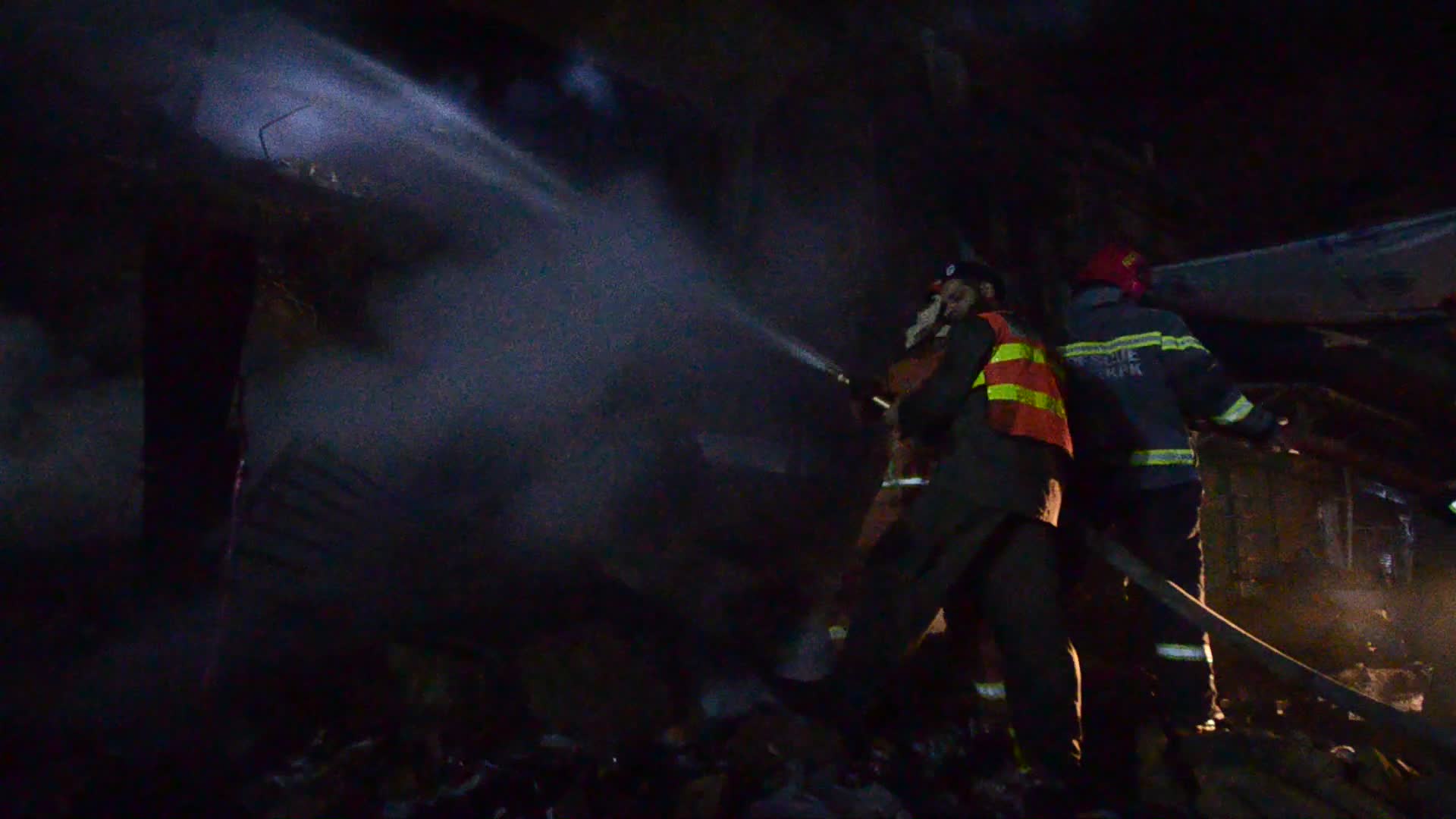 Firefighters At Work After a Fire In A Store In Peshawar, Pakistan