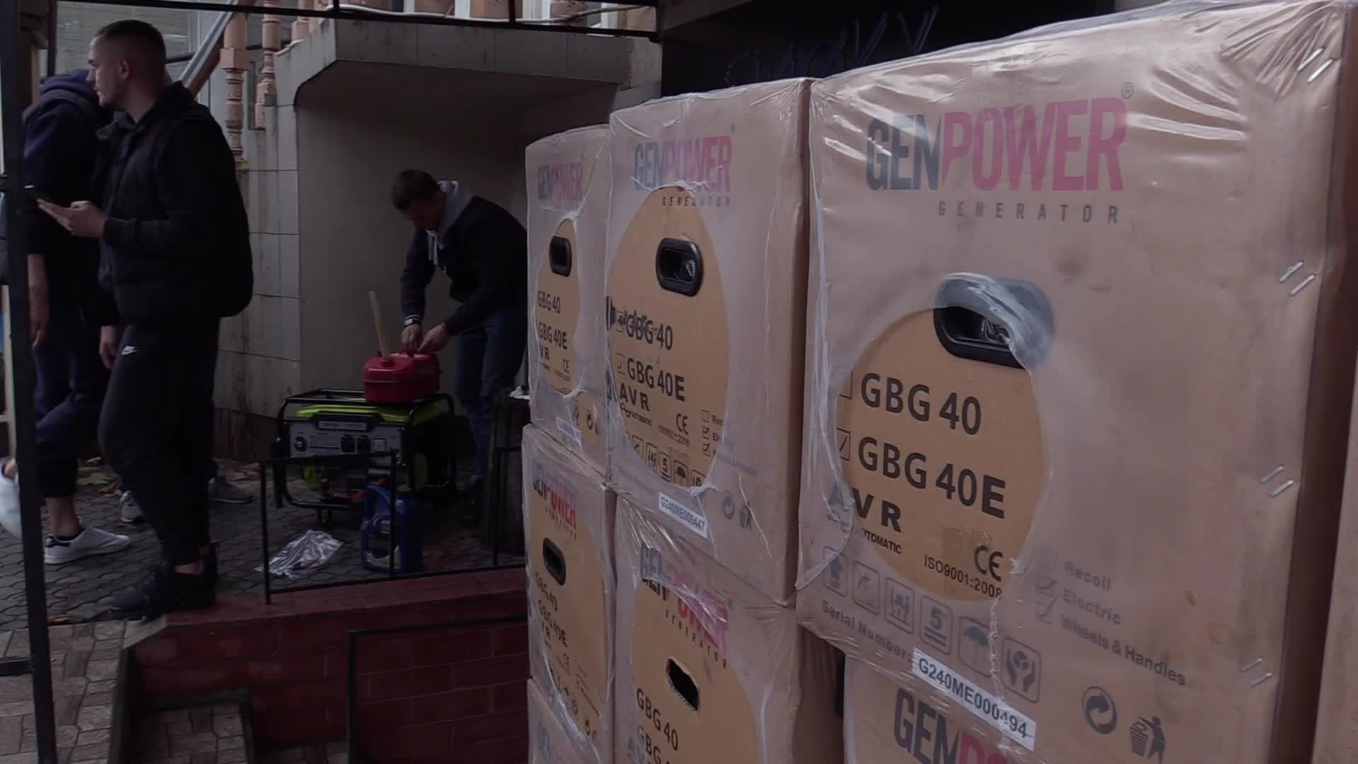 Ukrainians install a electricity generator outside the entrance to a store during emergency power blackout in Odesa