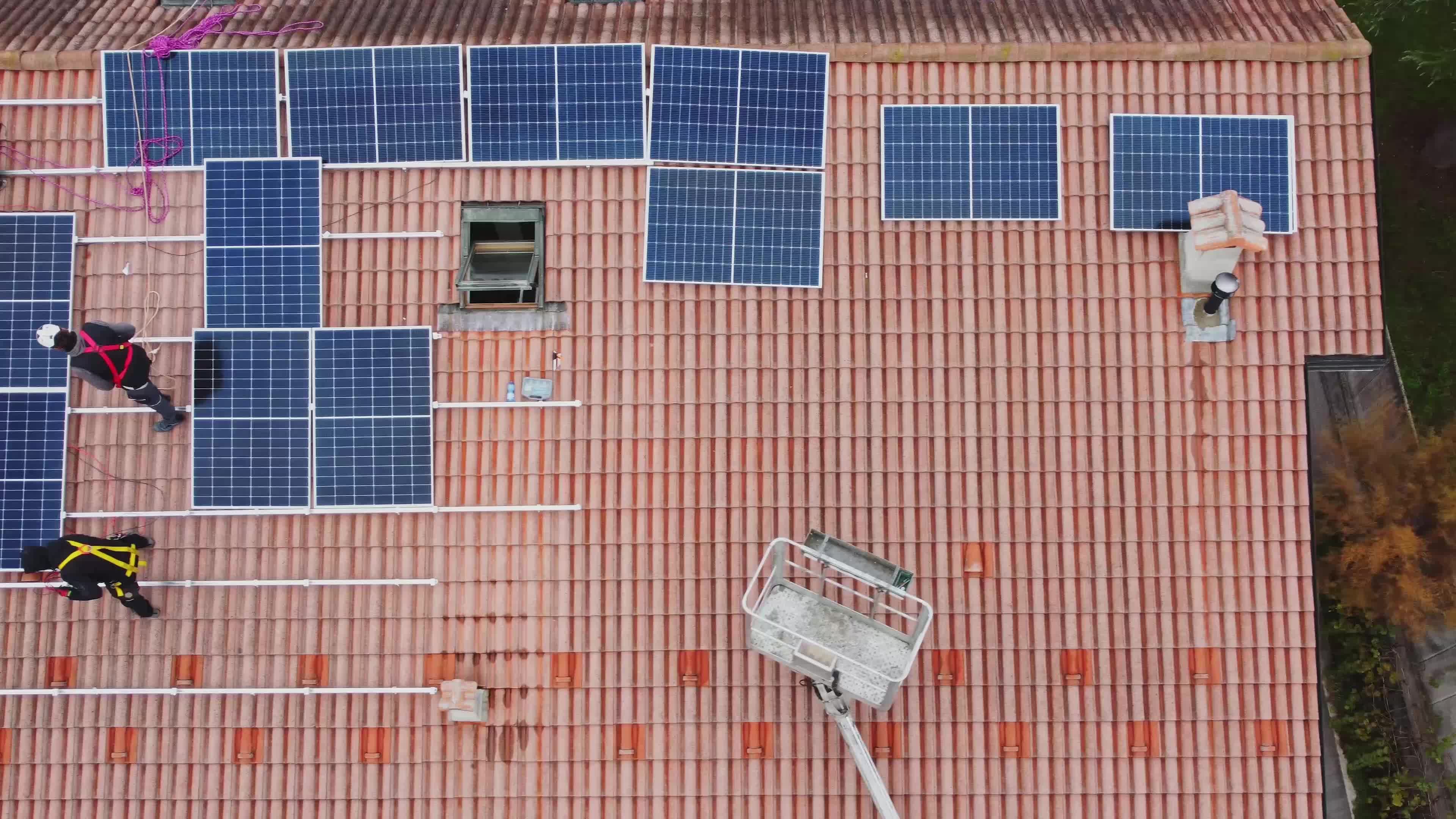 Solar technicians installing solar panels on residential roof