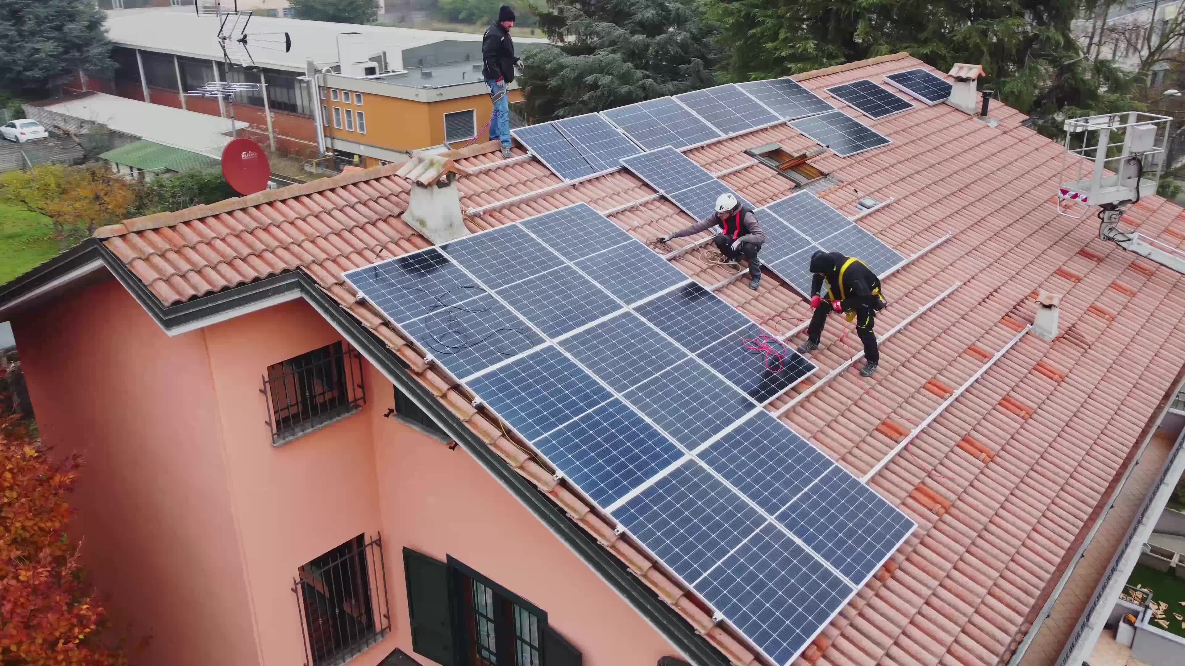 Solar technicians installing solar panels on residential roof