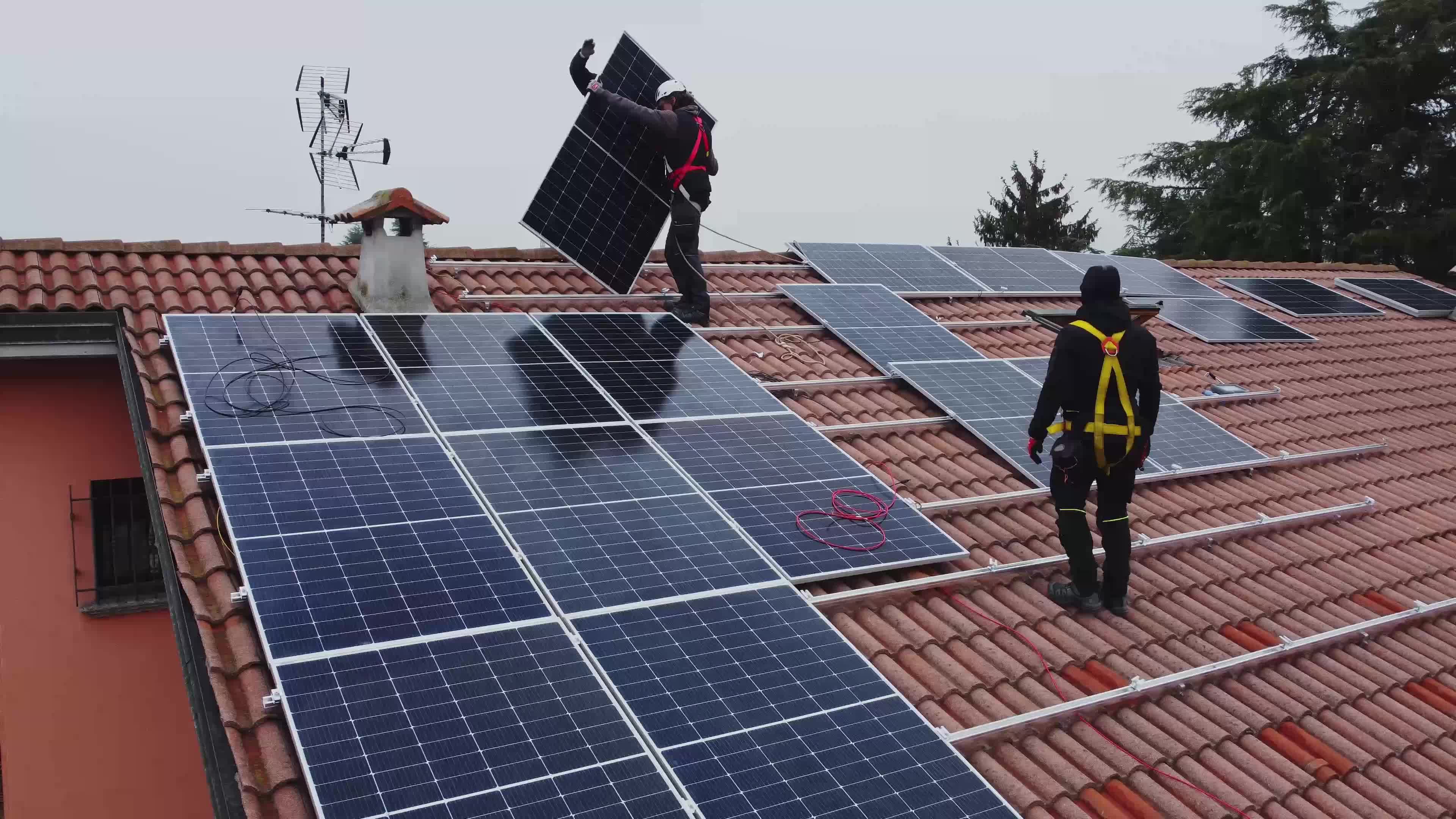 Solar technicians installing solar panels on residential roof