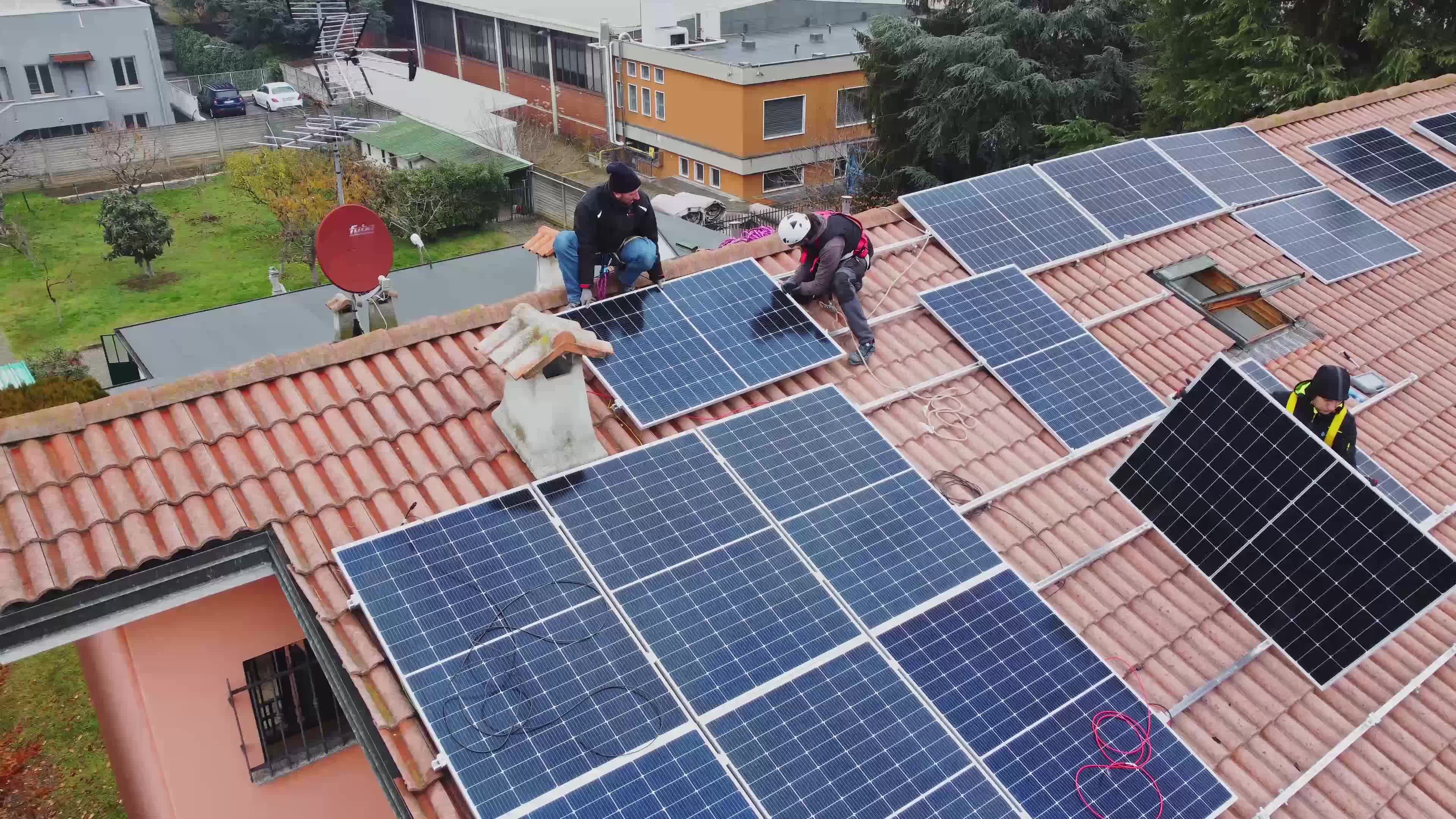 Solar technicians installing solar panels on residential roof