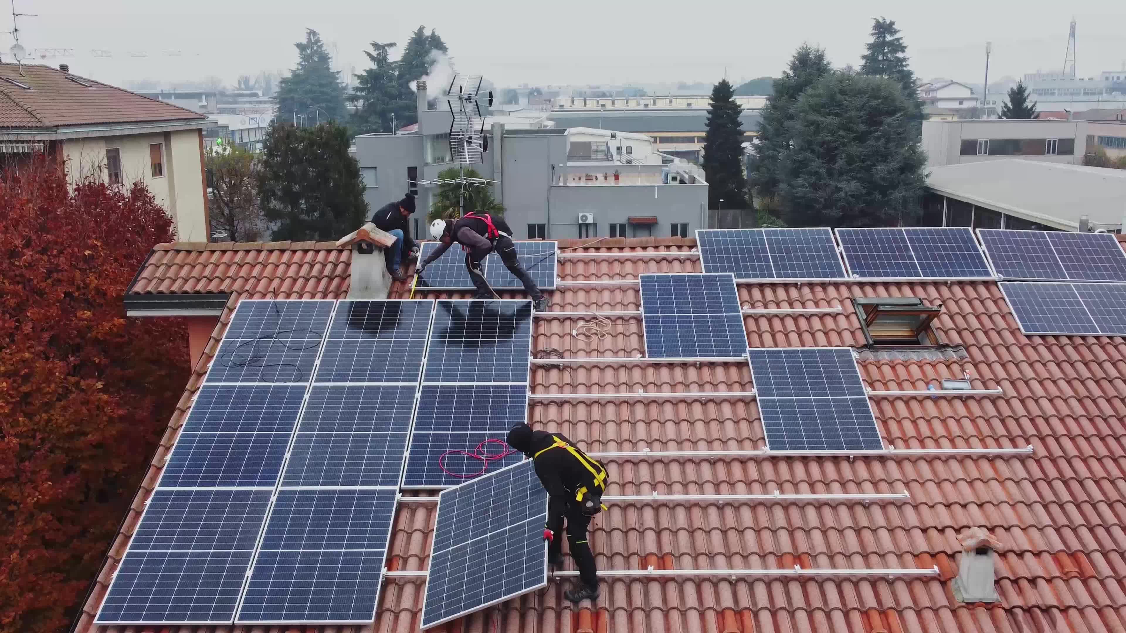 Solar technicians installing solar panels on residential roof