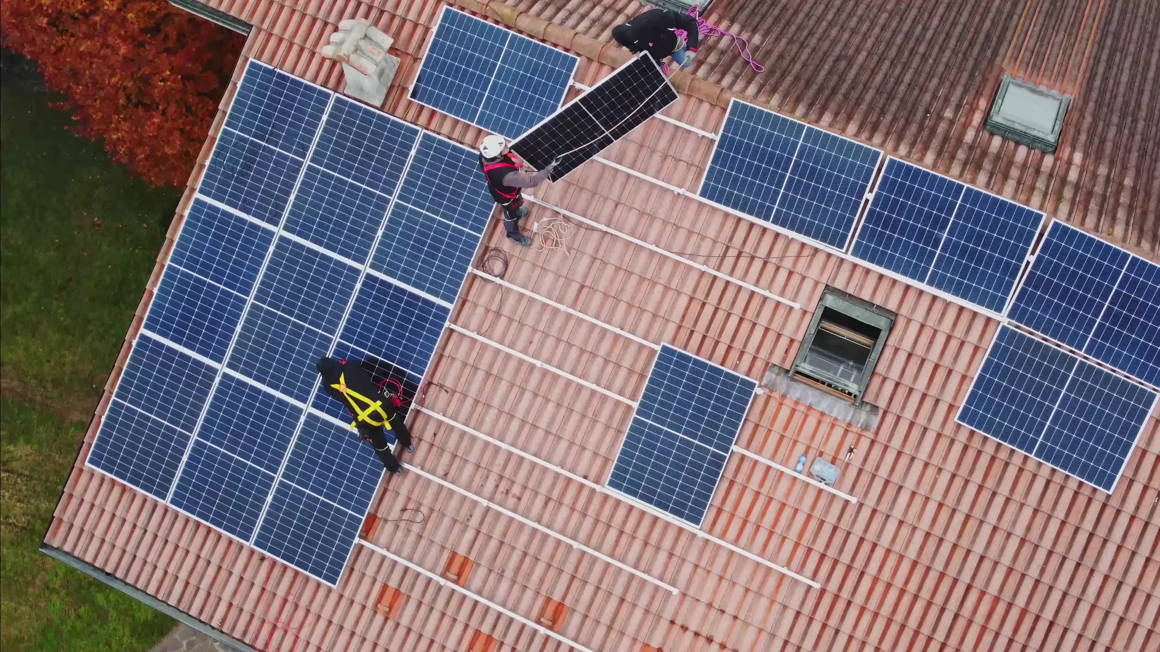 Solar technicians installing solar panels on residential roof