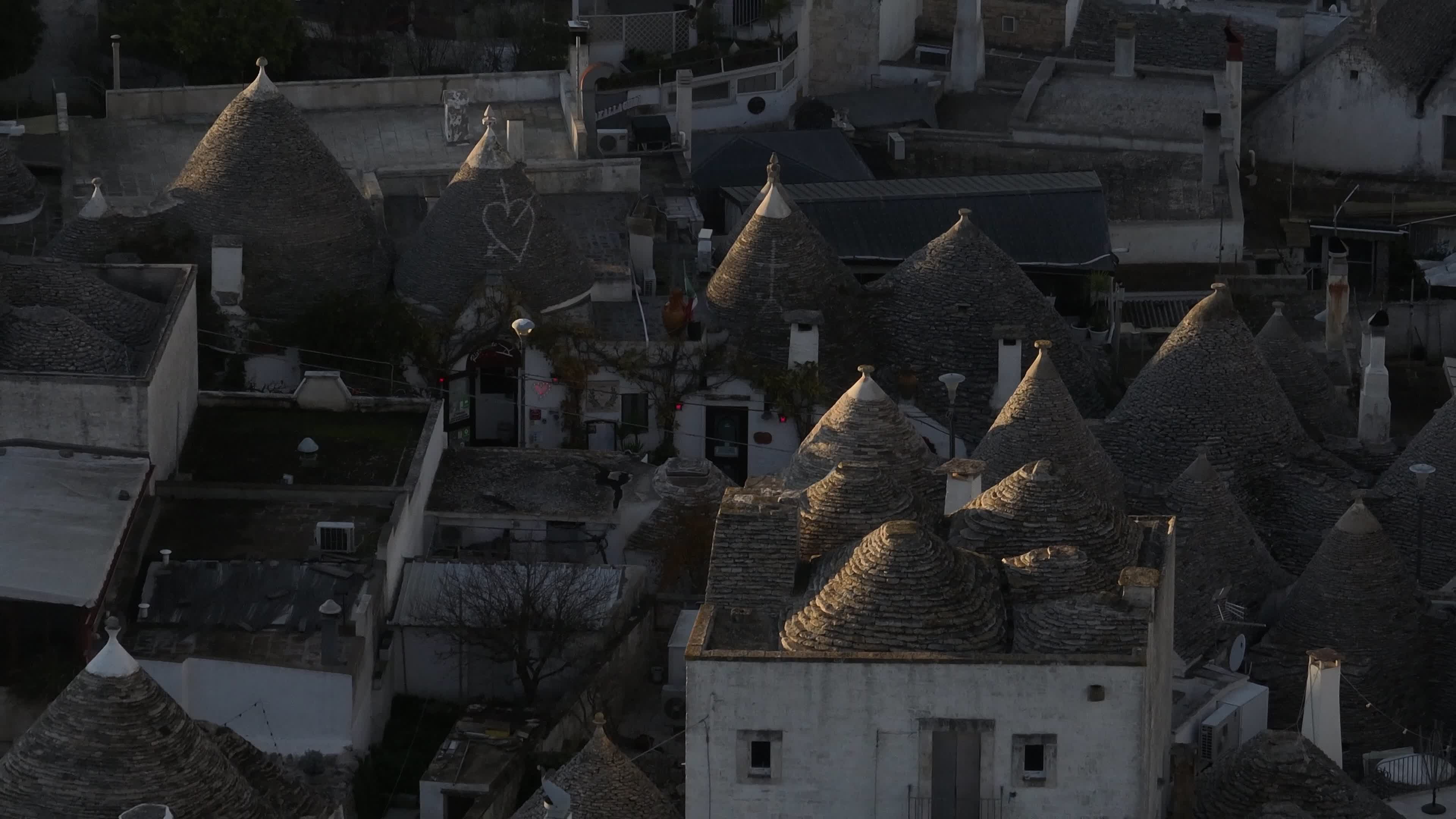 Drone View Of UNESCO World Heritage-listed Trulli Of Alberobello At Sunset