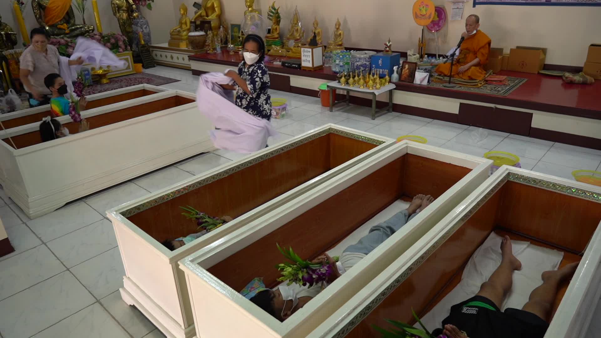 Thai People Lie in Coffins to Welcome in New Year in Bangkok.