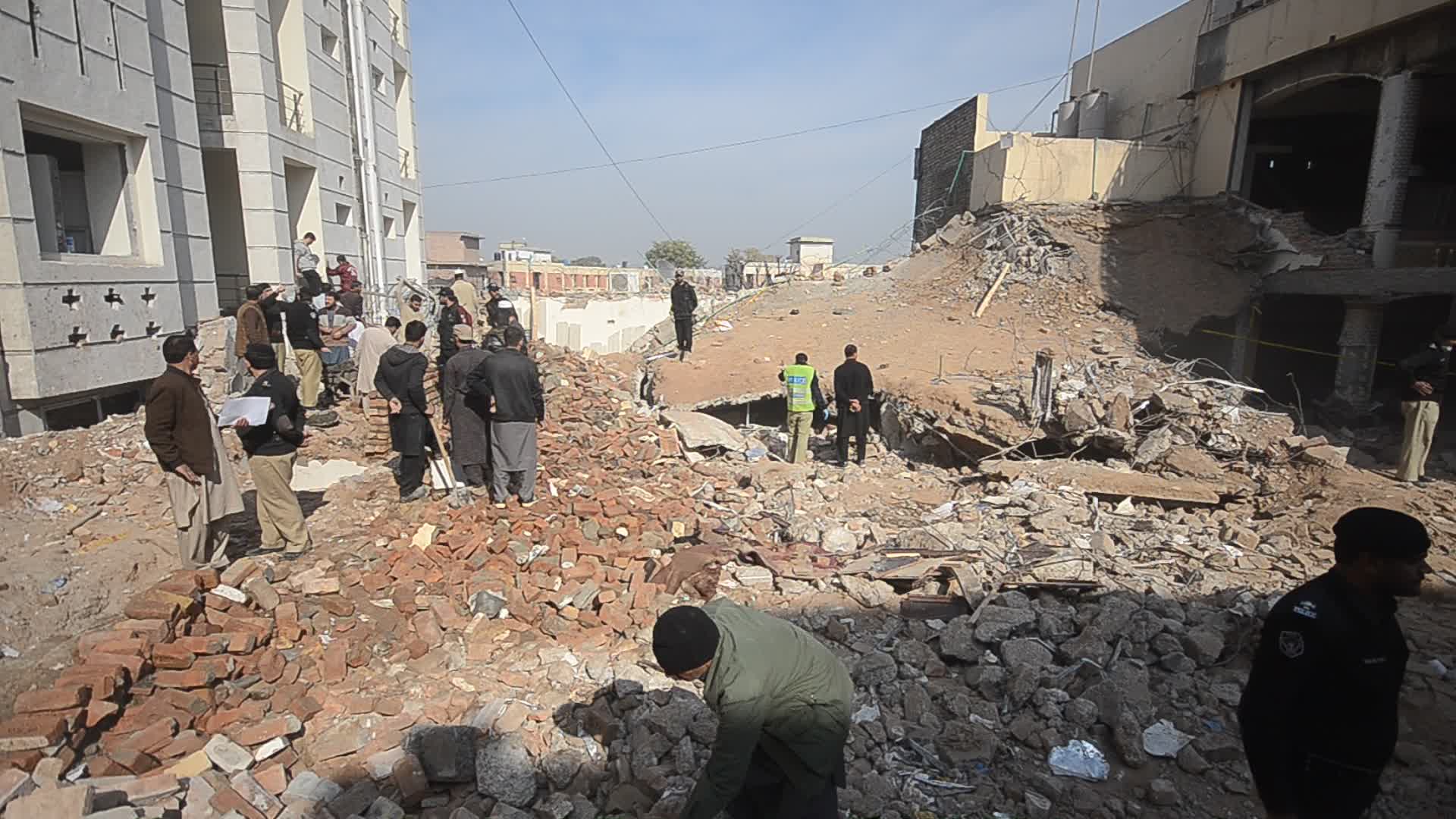 Police secure area of suicide bomb blast at a mosque that killed 100 people