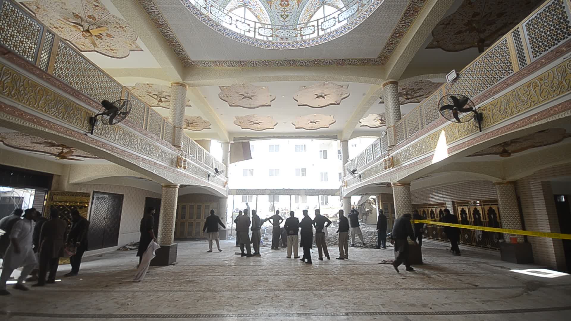 Police secure area of suicide bomb blast at a mosque that killed 100 people