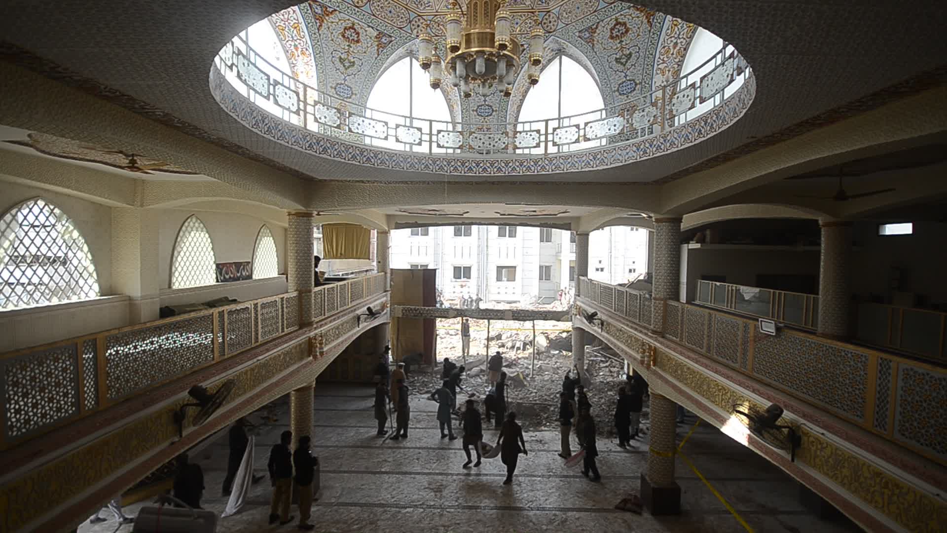 Police secure area of suicide bomb blast at a mosque that killed 100 people