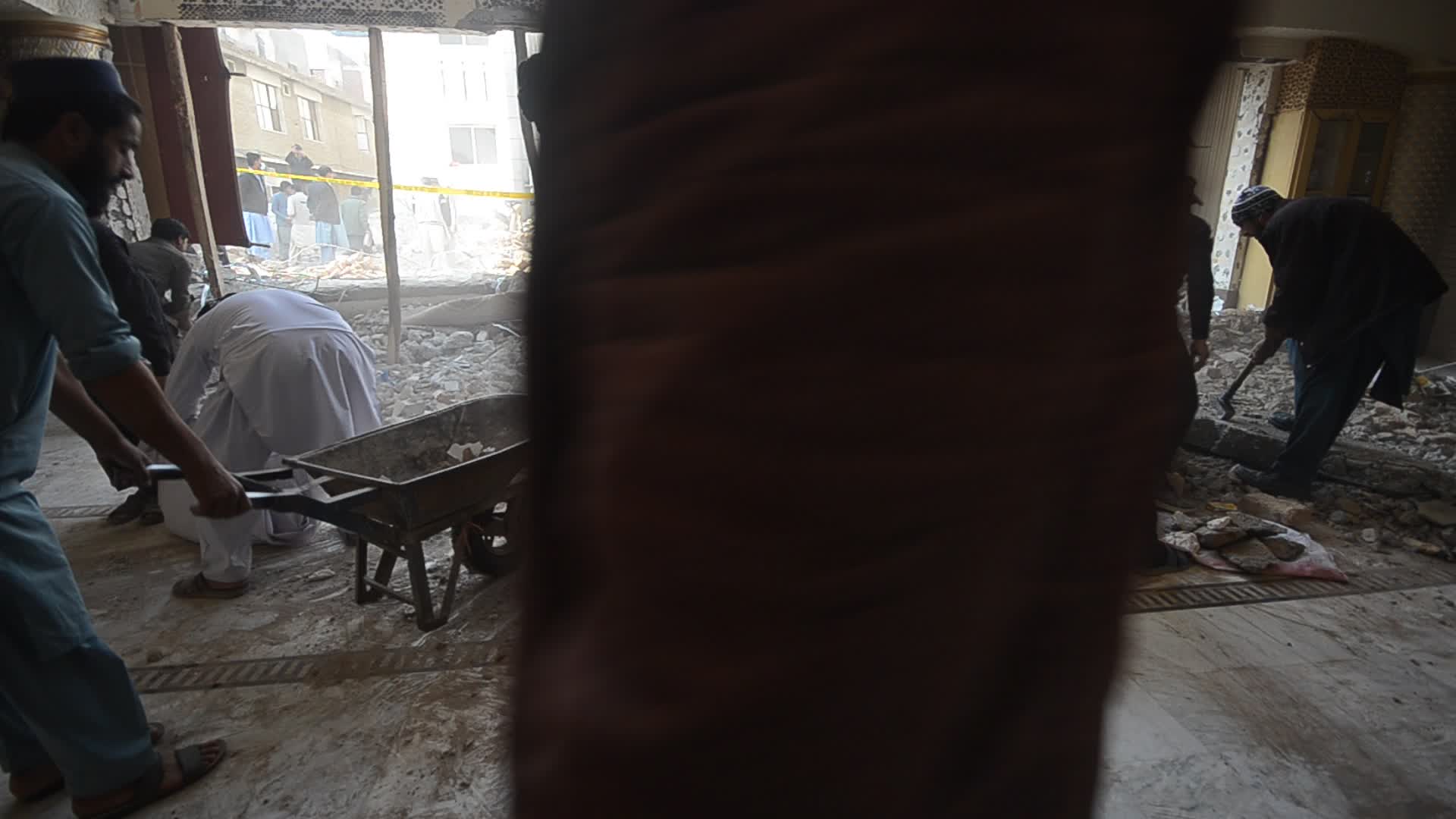 Police secure area of suicide bomb blast at a mosque that killed 100 people