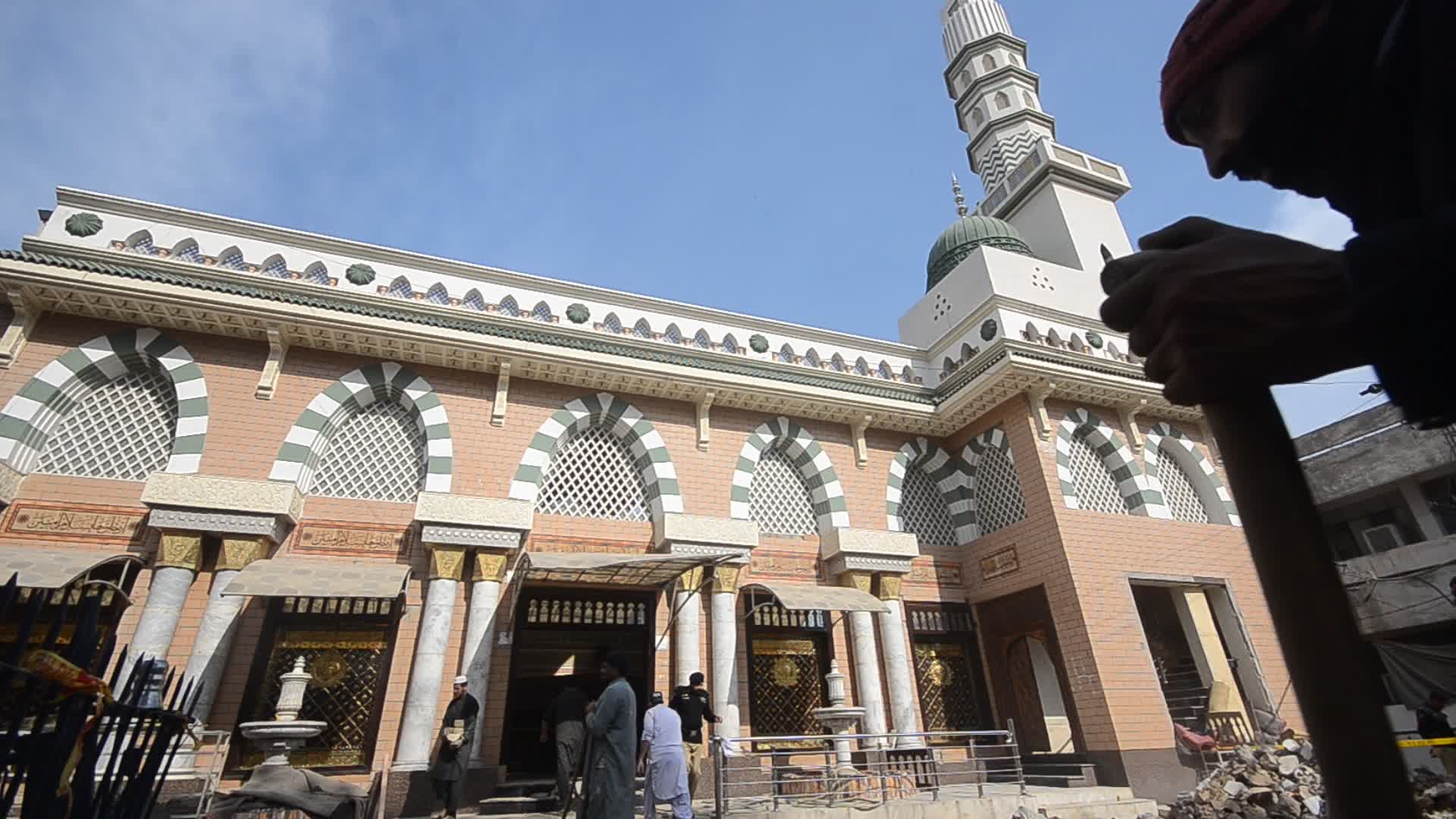 Police secure area of suicide bomb blast at a mosque that killed 100 people