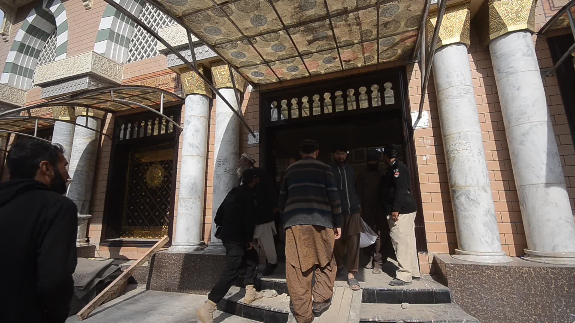 Police secure area of suicide bomb blast at a mosque that killed 100 people