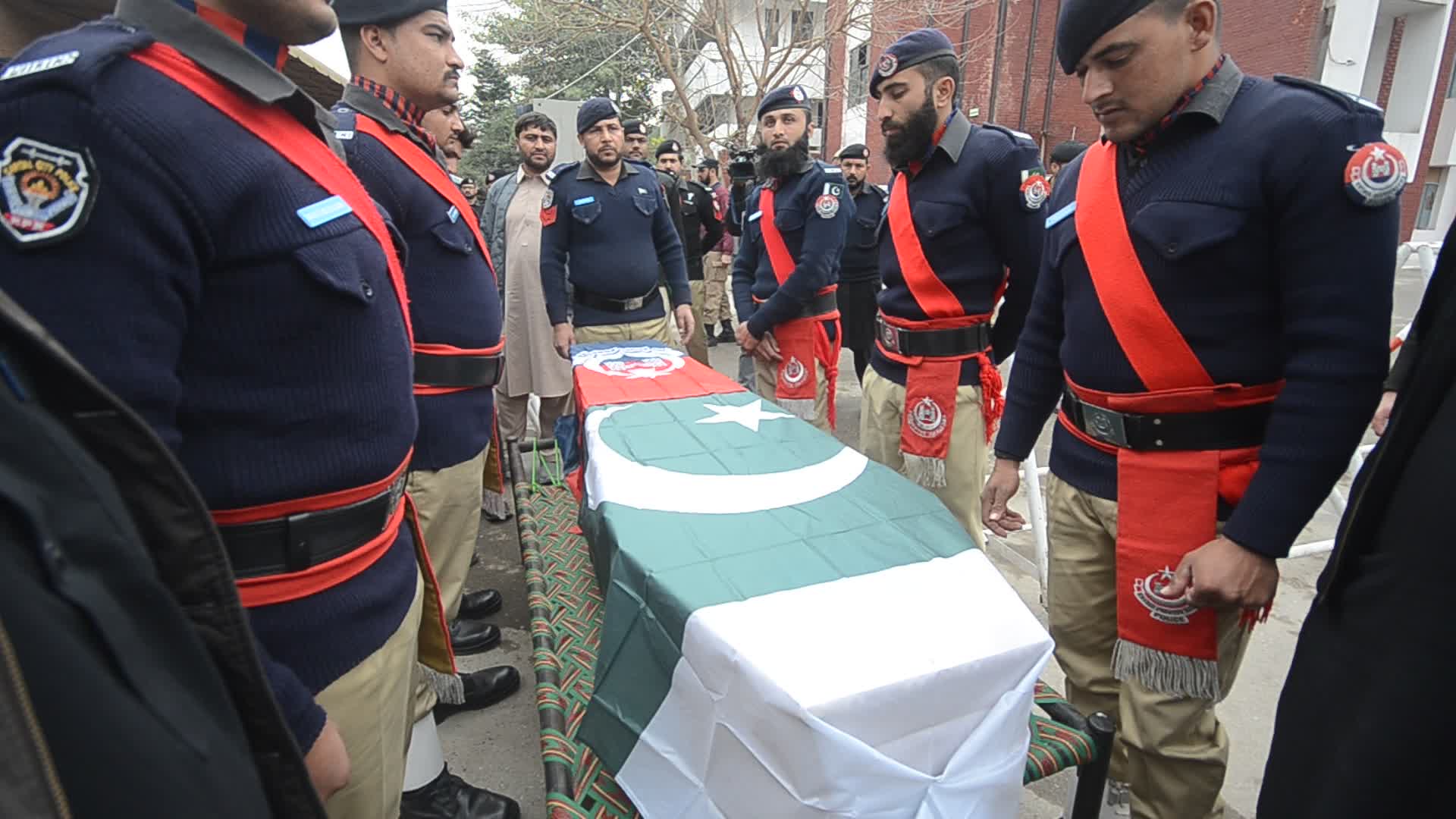 Funeral of a police official killed in a suicide bomb blast at a mosque
