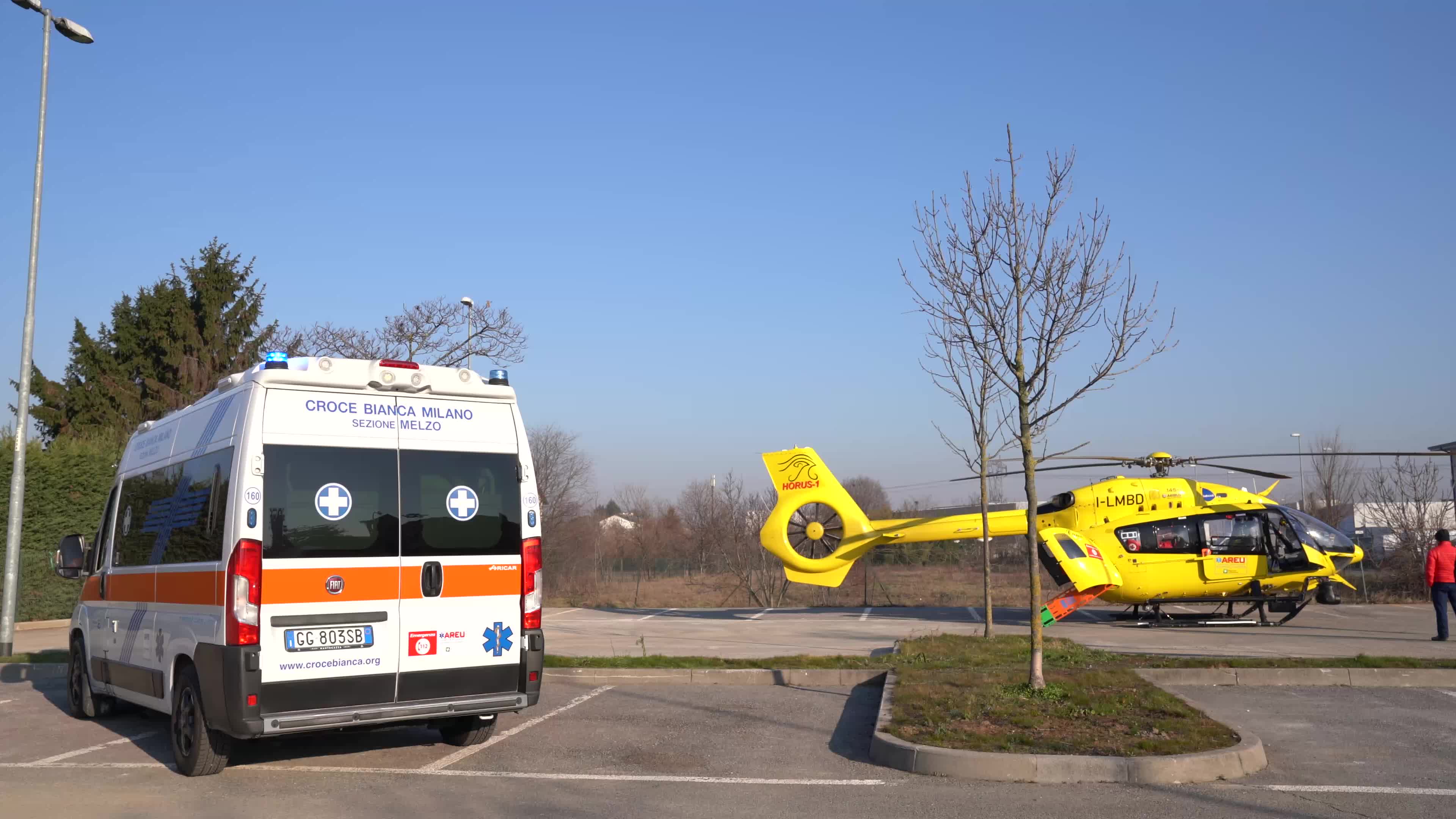 Ambulance and Medical helicopter landed in a public car parking