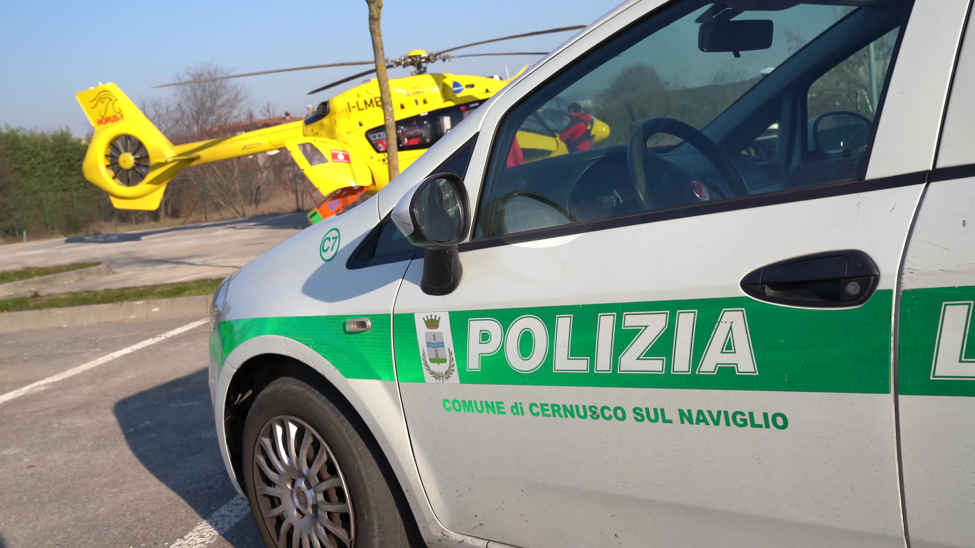 Police car and Medical helicopter landed in a public car parking