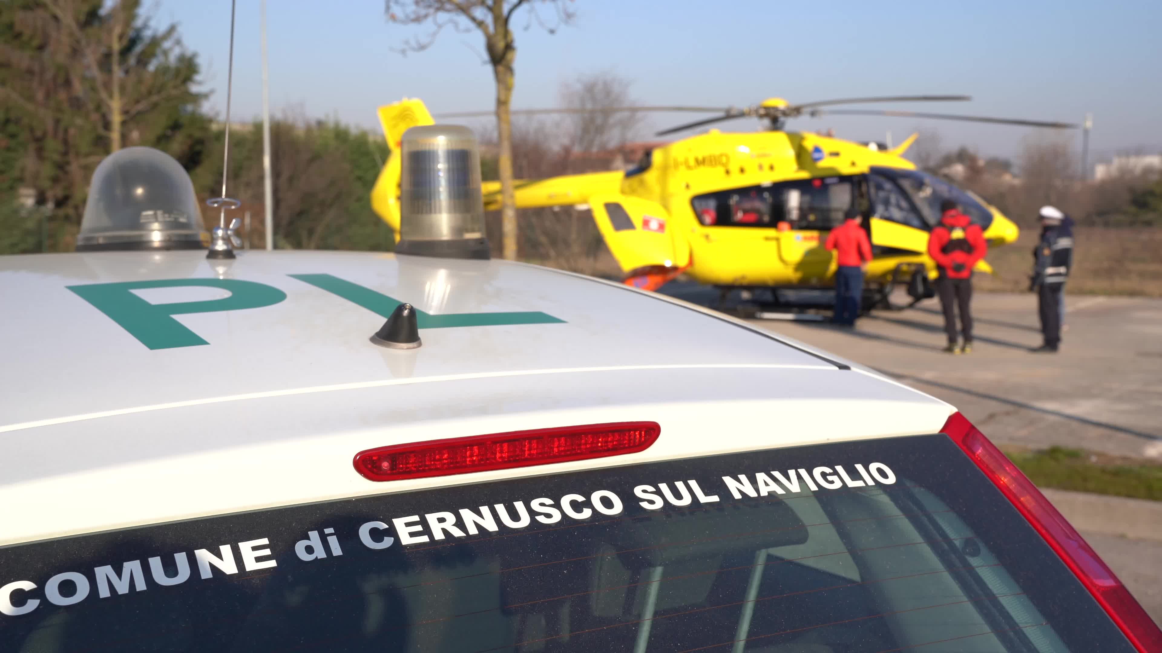 Police car and Medical helicopter landed in a public car parking