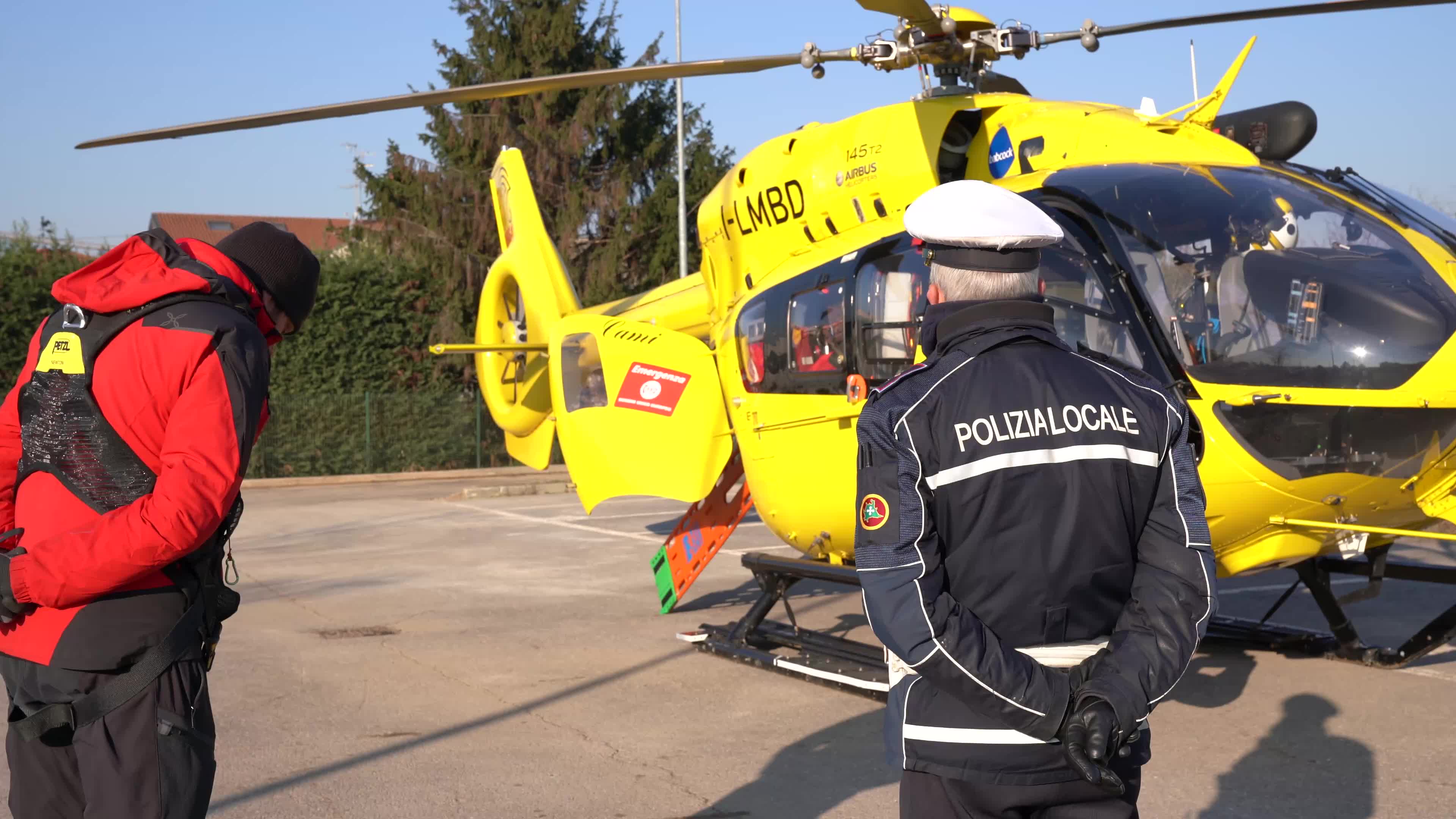Policeman and Medical helicopter crew in a public car parking