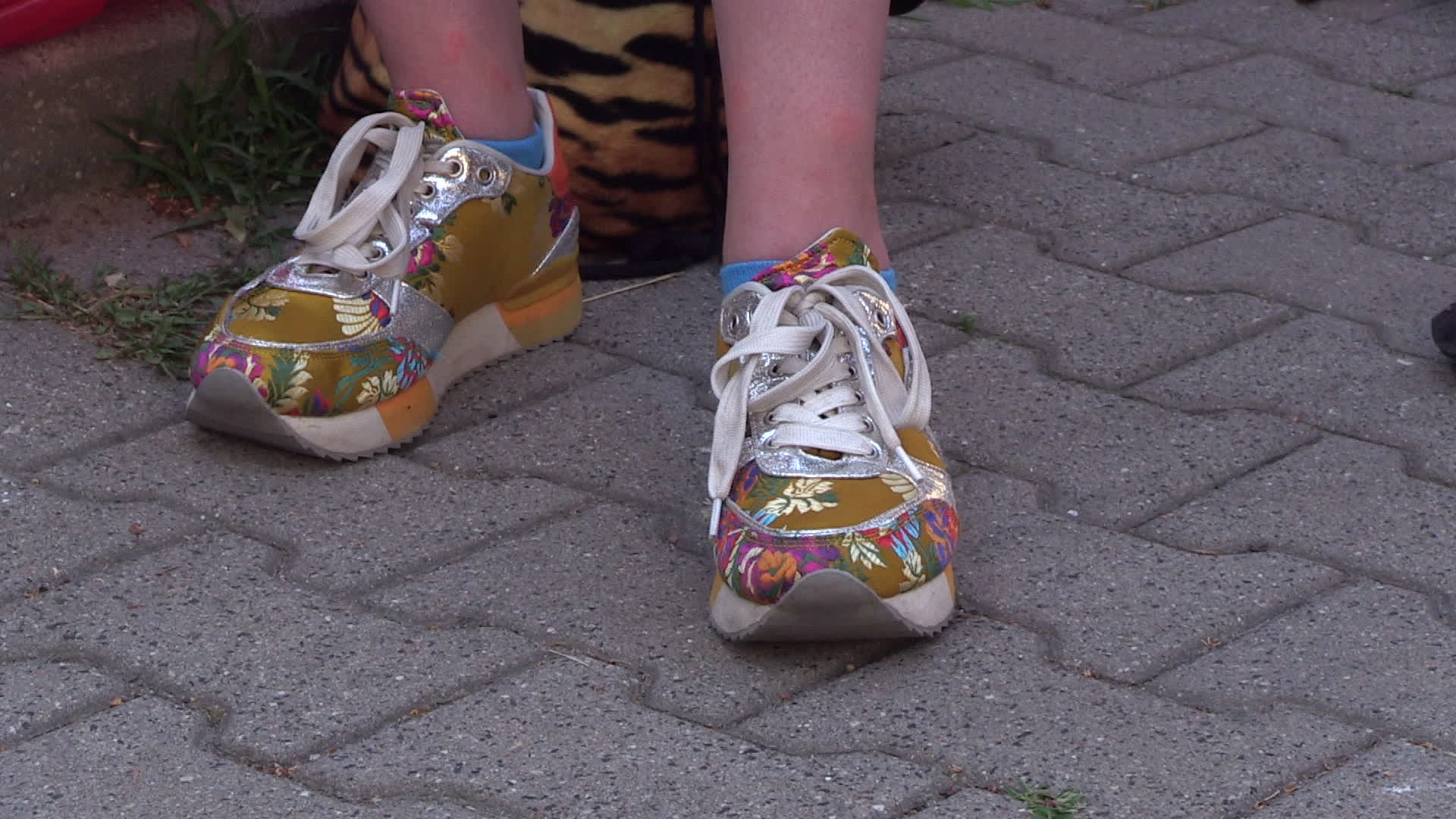 A woman wears trendy sneakers during a demonstration