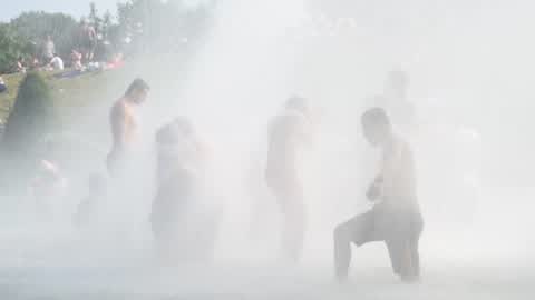 People bathe in the fountain of the Trocadero in Paris to escape the heat wave