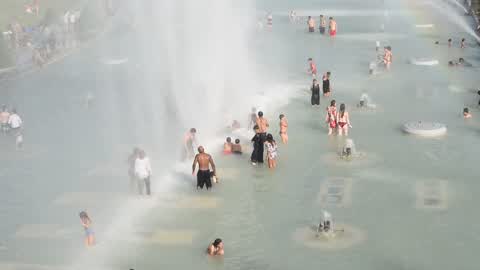 People bathe in the fountain of the Trocadero in Paris to escape the heat wave