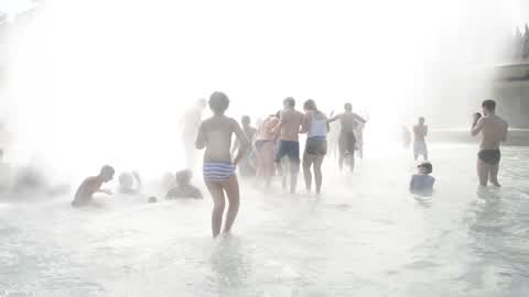 People bathe in the fountain of the Trocadero in Paris to escape the heat wave
