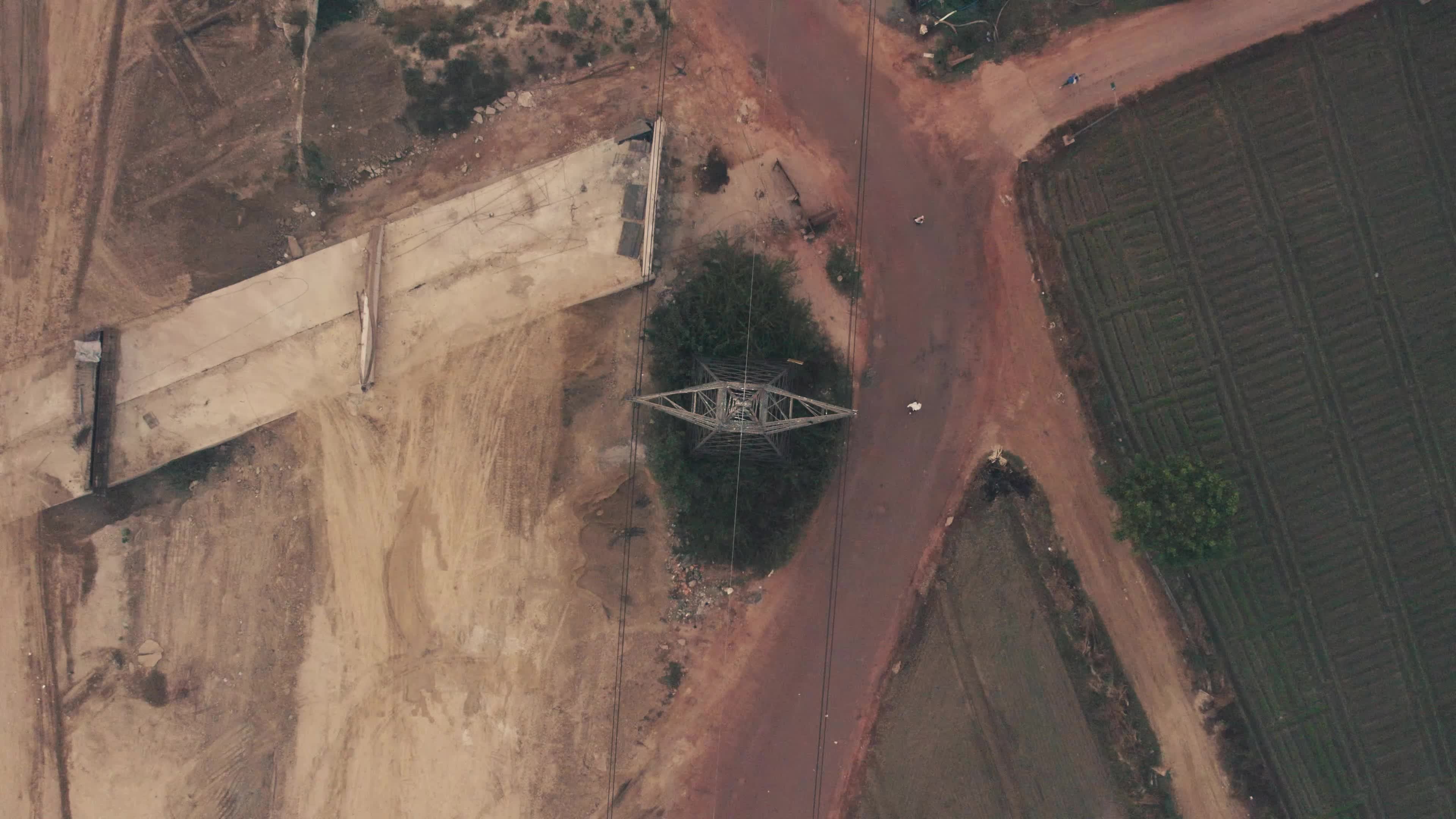 Aerial View of Electric Pylon next to an under-construction highway near the outskirt of New Delhi, India
