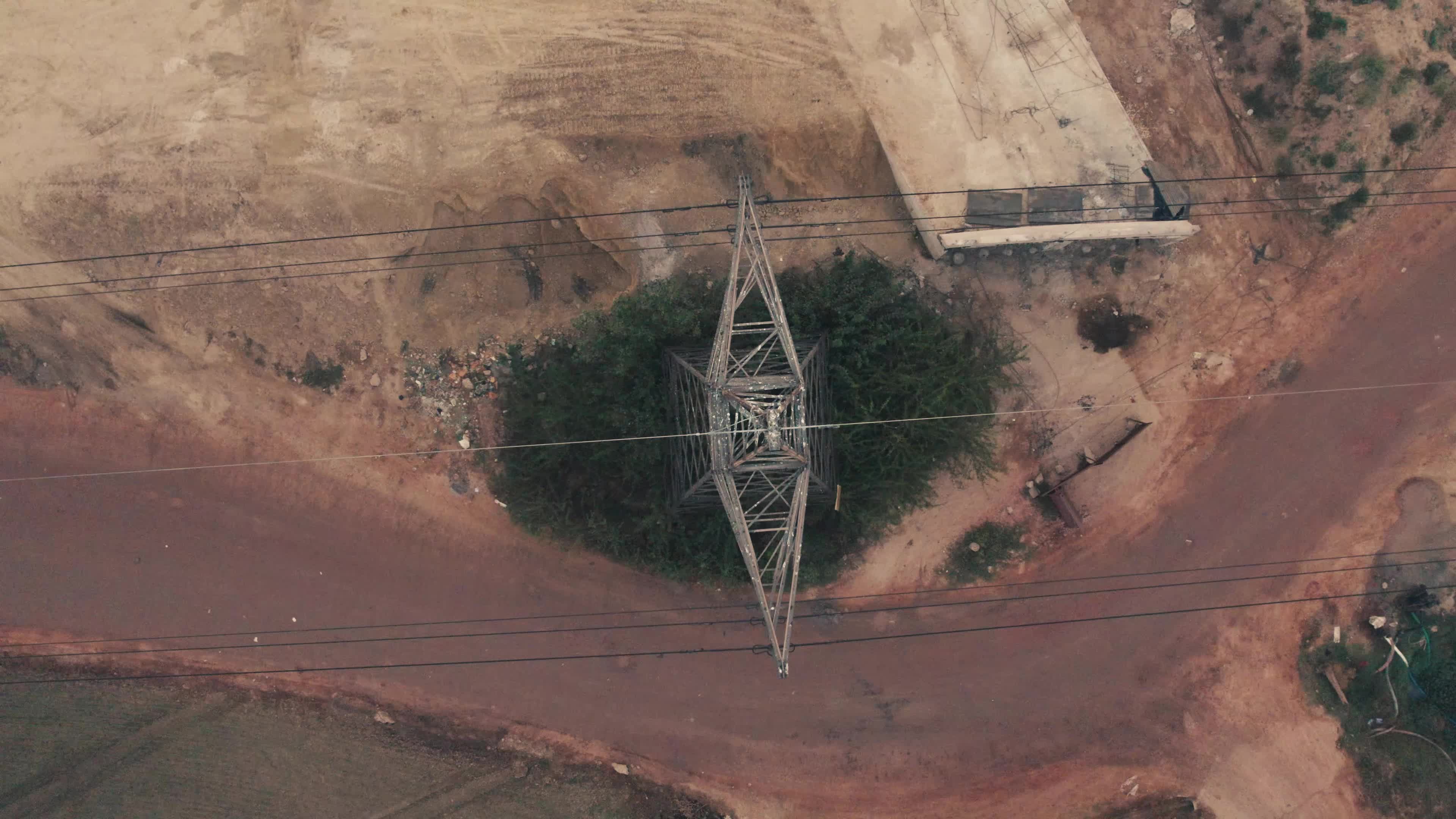 Aerial View of Electric Pylon next to an under-construction highway near the outskirt of New Delhi, India