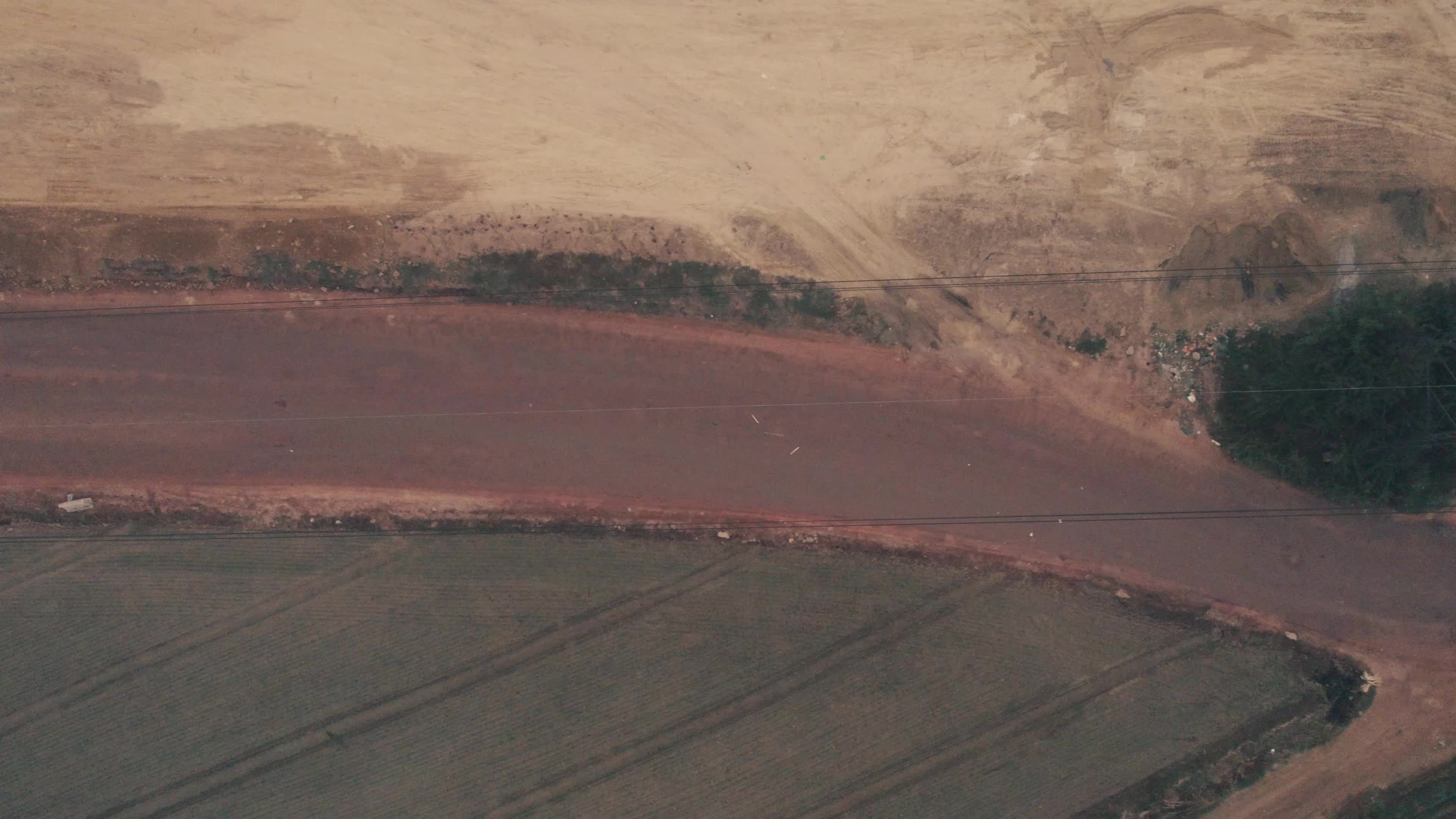 Aerial View of Electric Pylon next to an under-construction highway near the outskirt of New Delhi, India