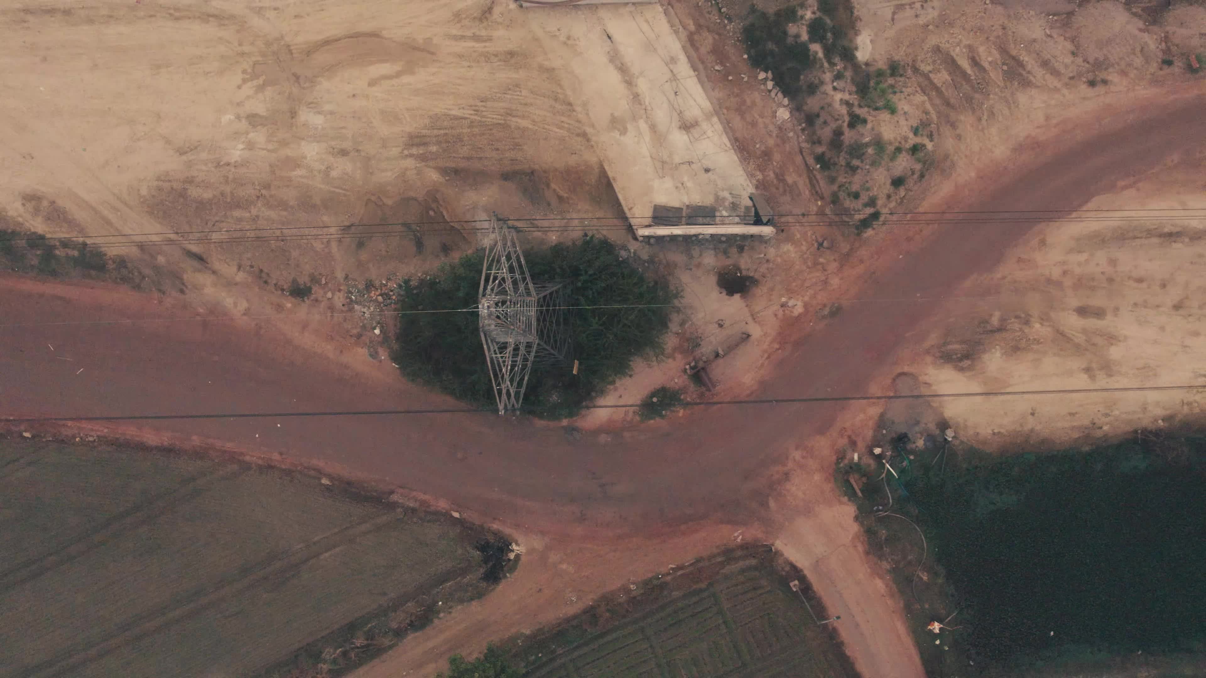 Aerial View of Electric Pylon next to an under-construction highway near the outskirt of New Delhi, India