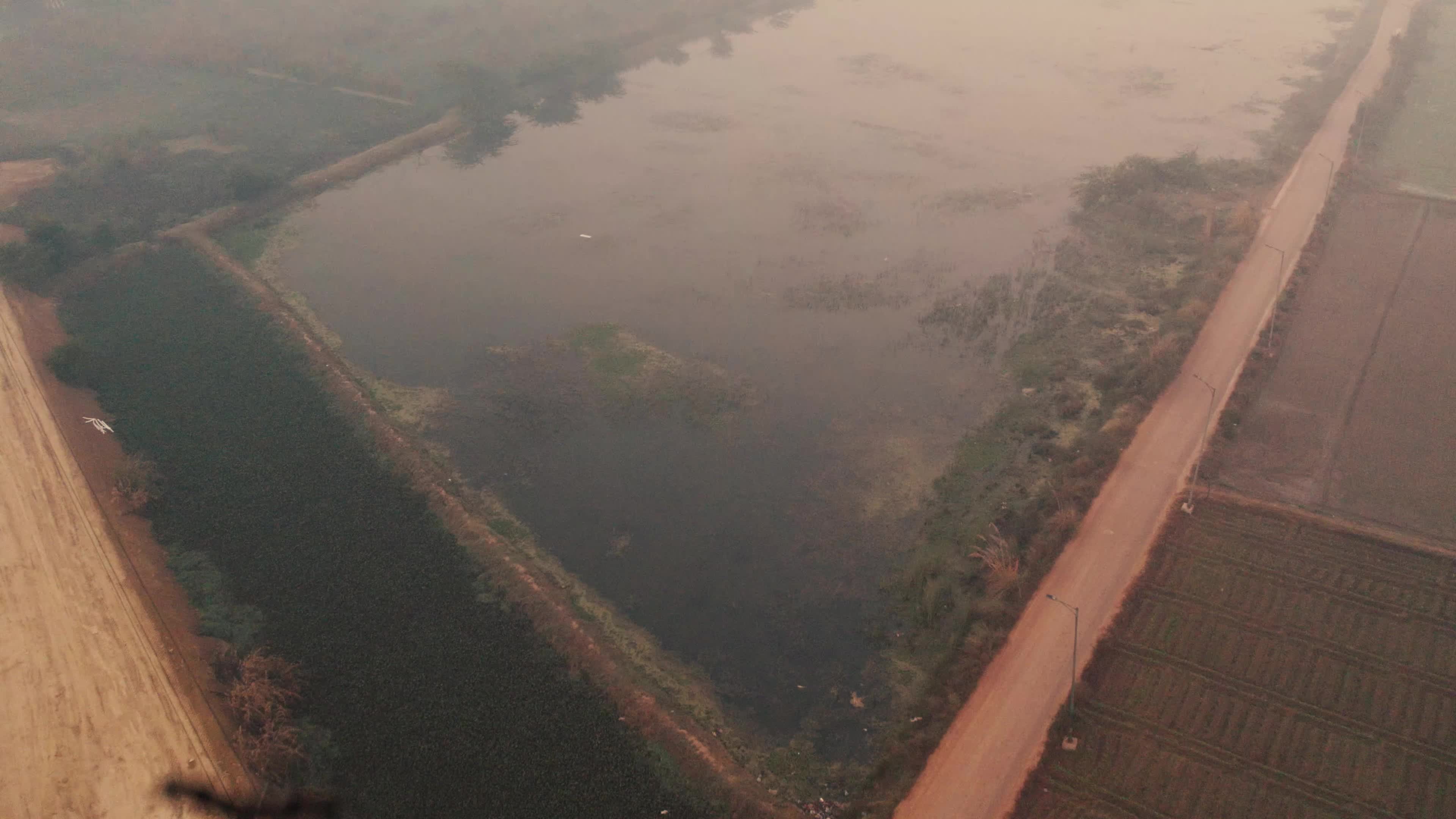 Aerial View of Electric Pylon next to an under-construction highway near the outskirt of New Delhi, India