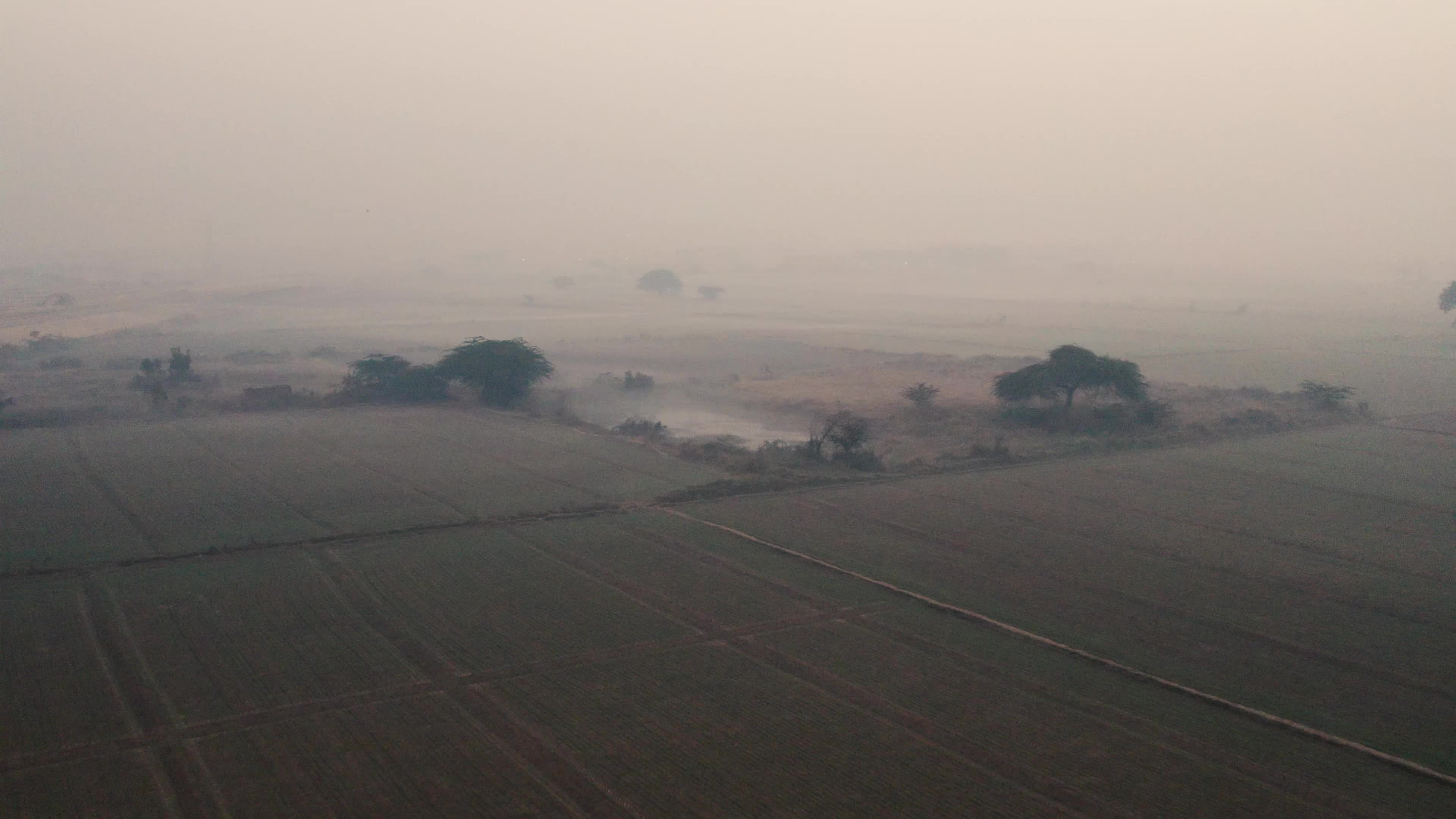 Aerial Video of empty fields on a winter foggy morning.