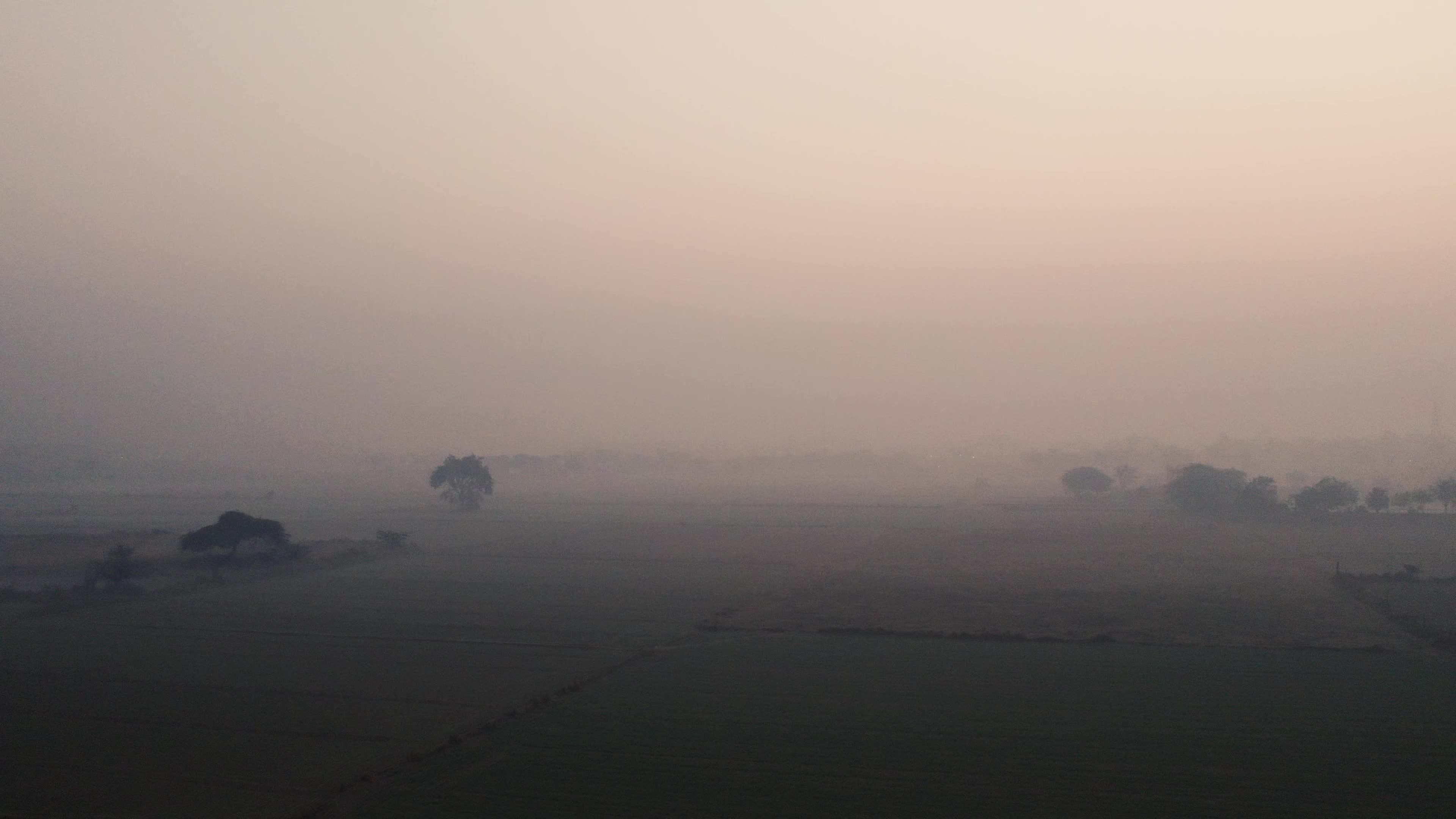 Aerial Video of empty fields on a winter foggy morning.
