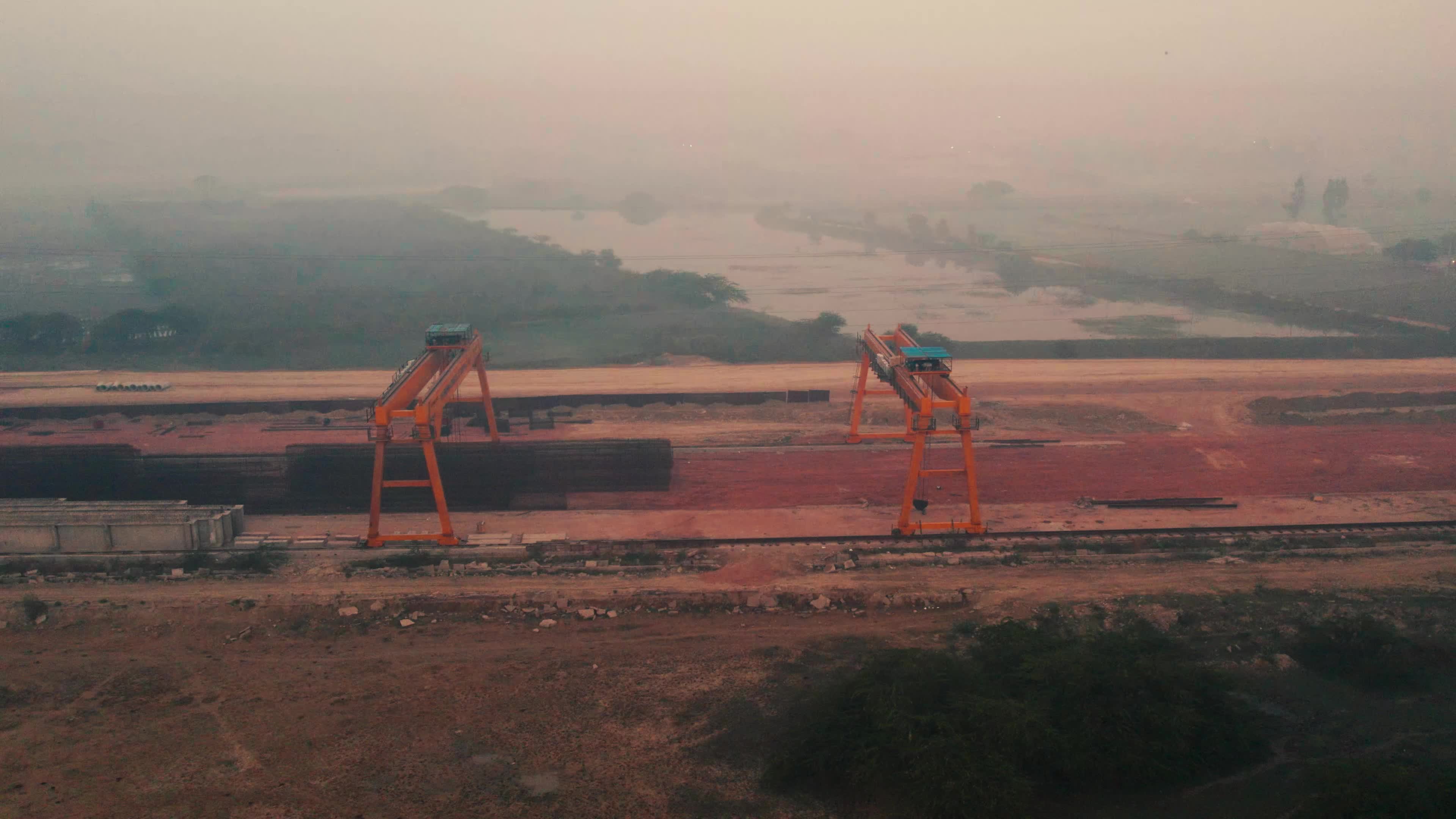 Aerial view of an under-construction highway and the Heavy Machinery used for the construction and maintain pace of roads and bridges