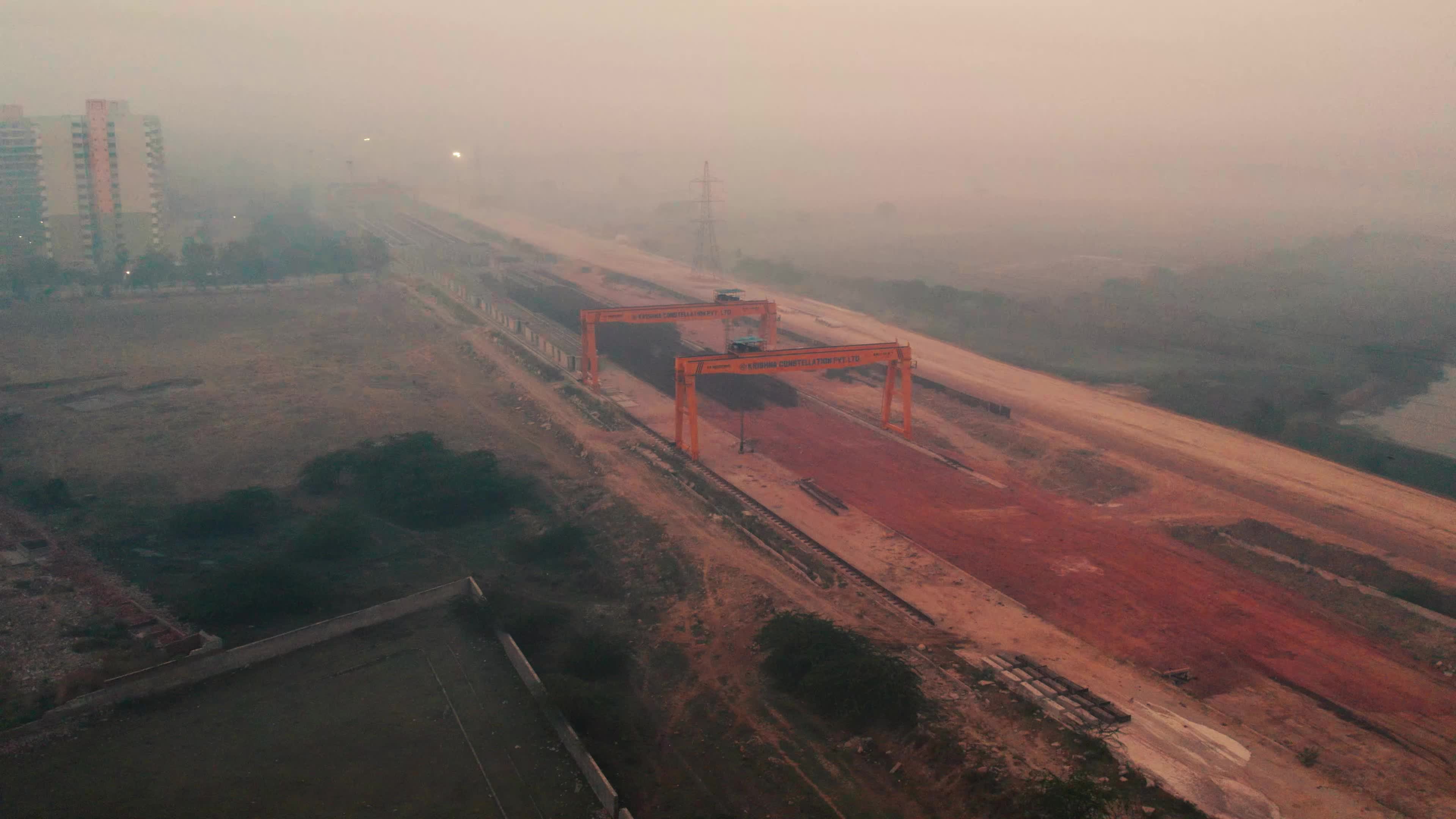 Aerial view of an under-construction highway and the Heavy Machinery used for the construction and maintain pace of roads and bridges