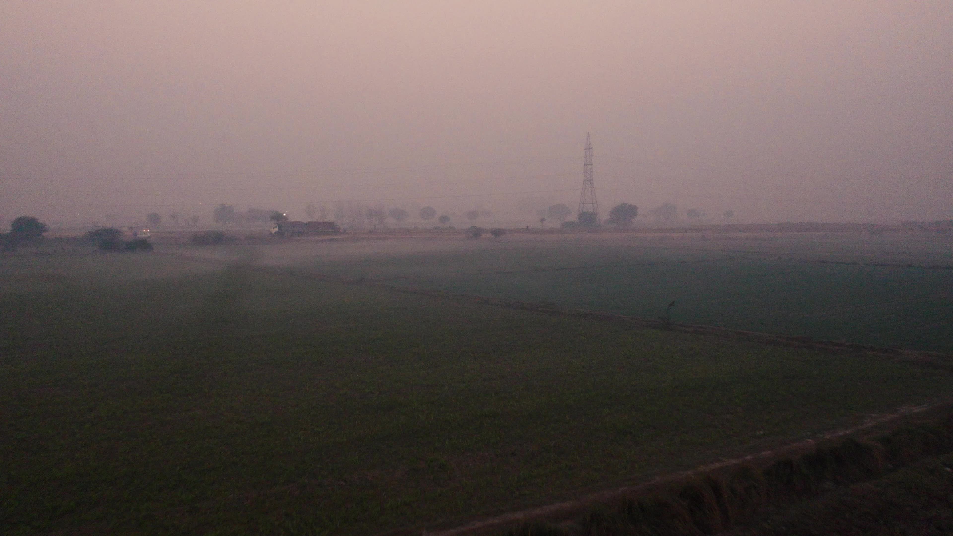Aerial view of a foggy and misty Morning with Under Construction Highway and moving traffic on the outskirts of New Delhi, India