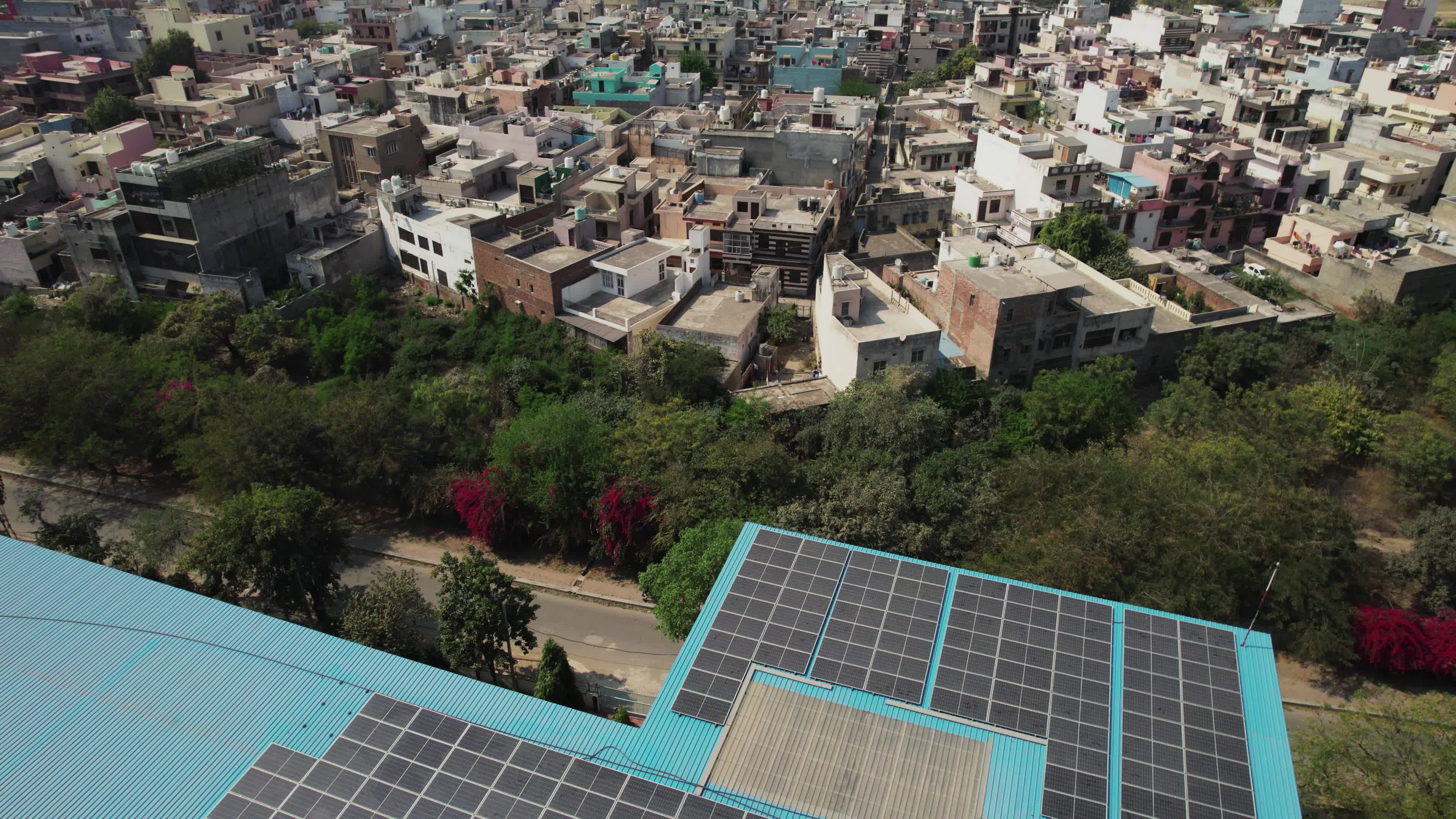 4K Aerial overpopulated View of Industrial & Residential Estate in Bahadurgarh City with elevated Metro train tracks, Harayana, India - stock video