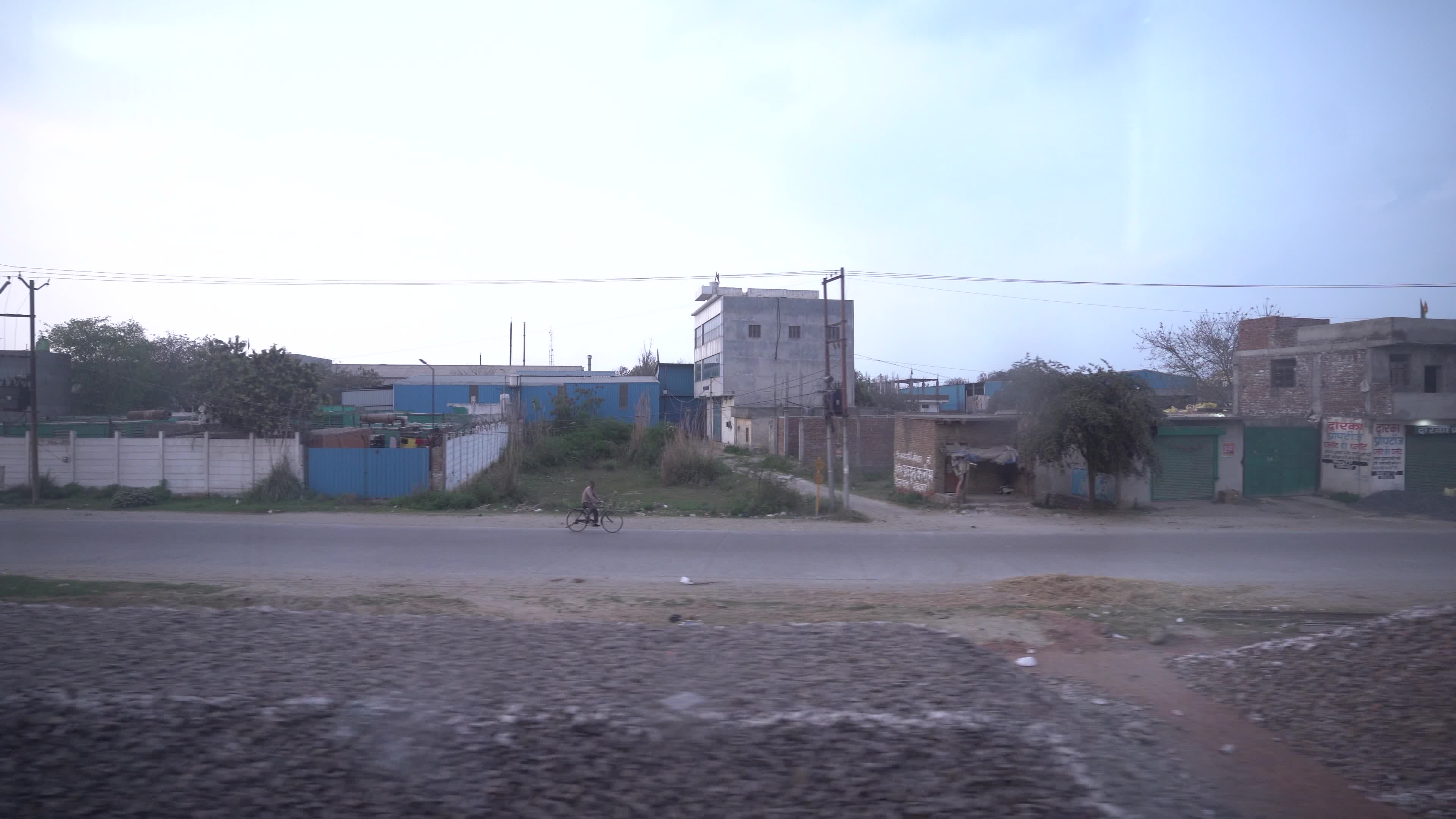 Views outside the window of a moving passenger train of Indian Railways in India